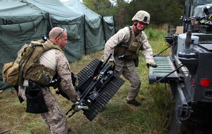 Two explosive ordnance disposal technicians with EOD Company, 8th Engineer Support Battalion, 2nd Marine Logistics Group, load a MK II Talon Robot onto a humvee during Improvised Explosive Device Response training at Camp Dave South Training Ground, one of the many training areas aboard Camp Lejeune, N.C., Nov. 4, 2010. During the training, EOD technicians were given the opportunity to brush up on their skills and find simulated IEDs scattered throughout the training grounds by fellow technicians. (U.S. Marine Corps photo by Pfc. Franklin E. Mercado)
