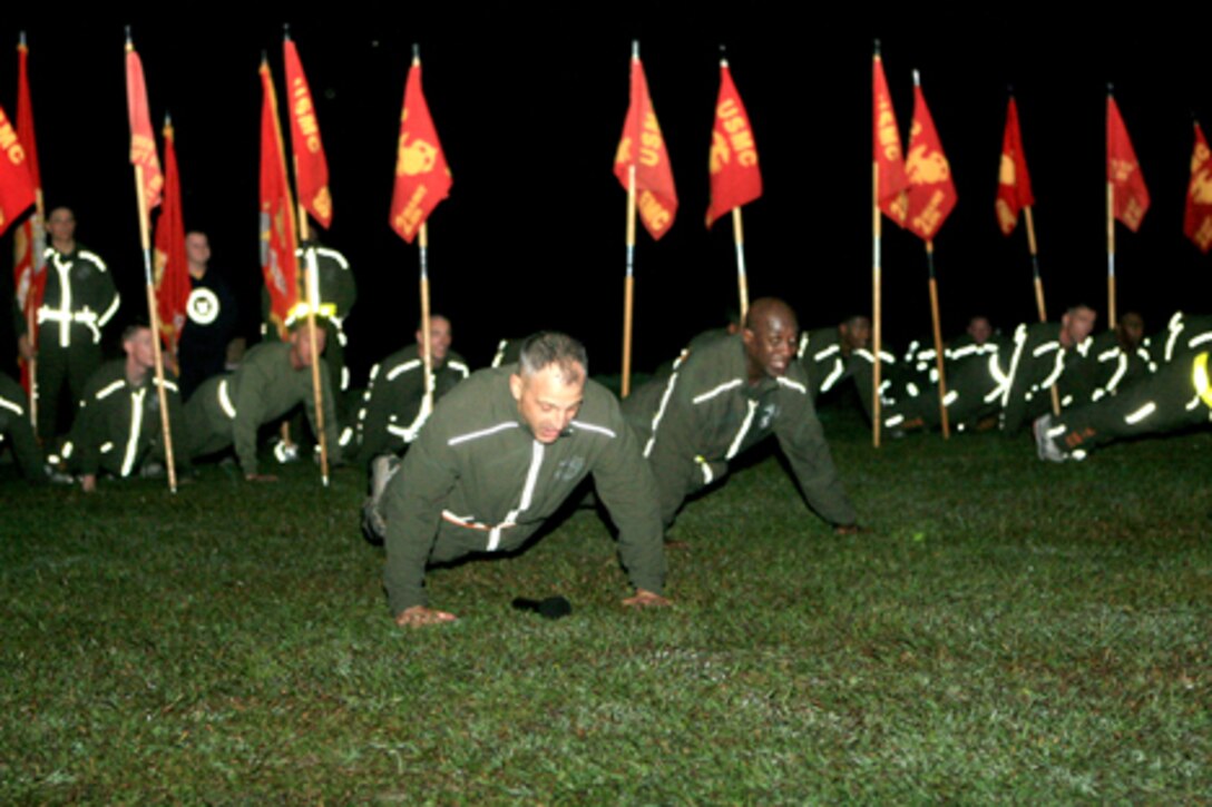 Brig. Gen. Michael Dana, 2nd Marine Logistics Group commanding general (left), and the sergeant major of the Marine Corps, Sgt. Maj. Carlton W. Kent (right), lead the MLG Marines and sailors in pyramid push-ups at the conclusion of the 2nd MLG fun run aboard Camp Lejeune, N.C., Nov. 4, 2010.  Dana and Kent addressed the Marines in recognition of the Marine Corps’ 235th birthday.  (U.S. Marine Corps photo by Lance Cpl Anthony Kidd)