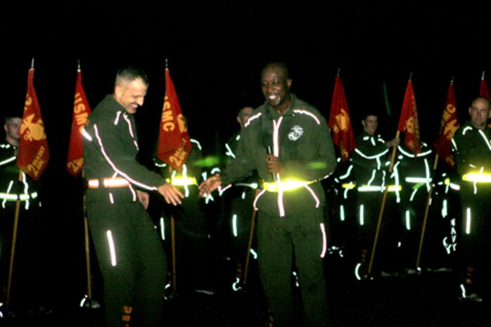 Brig. Gen. Michael Dana, 2nd Marine Logistics Group commanding general, passes a microphone to sergeant major of the Marine Corps, Sgt. Maj. Carlton W. Kent, to address the Marines and sailors of 2nd MLG after a fun run aboard Camp Lejeune, N.C., Nov. 4, 2010.  Kent spoke of past traditions in recognition of the Marine Corps’ 235th birthday.  (U.S. Marine Corps photo by Lance Cpl Anthony Kidd)