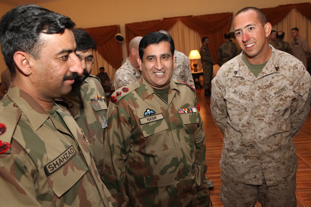 Sergeant Kenny Wilhite with 26th Marine Expeditionary Unit socializes with Pakistan military officers before a farewell dinner at Pano Aqil Cantonment hosted by 16 Division, Nov. 4, 2010. With the Pakistan military, 26th MEU Marines have been flying CH-53E Super Stallion Helicopters to isolated locations since early September and have transported more than 3.9 million pounds of World Food Programme flood relief supplies to 150 different locations in southern Pakistan. (Official USMC photo by Gunnery Sgt. Bryce Piper) (Released)::r::::n::