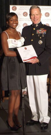 Tatiana Pile accepts her Marine Corps Scholarship Foundation Scholarship award from General James Amos, Assistant Commandant of the Marine Corps.