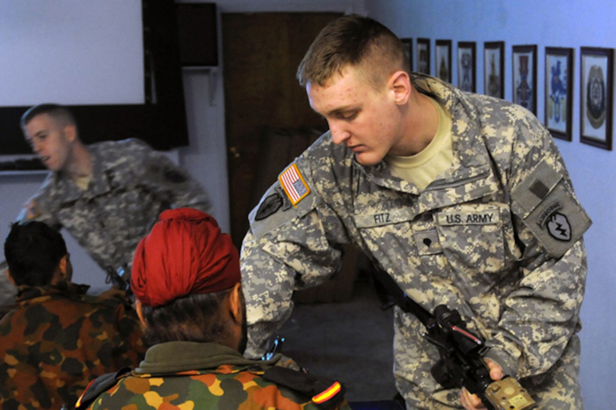 Spc. Grant Fitz, 4th Brigade Combat Team (Airborne), 25th Infantry Division shows an Indian Army soldier the M-4 carbine, Monday, at the Battle Command Training Center on Joint Base Elmendorf Richardson. (U.S. Army photo/Spc. Ashley Armstrong)
