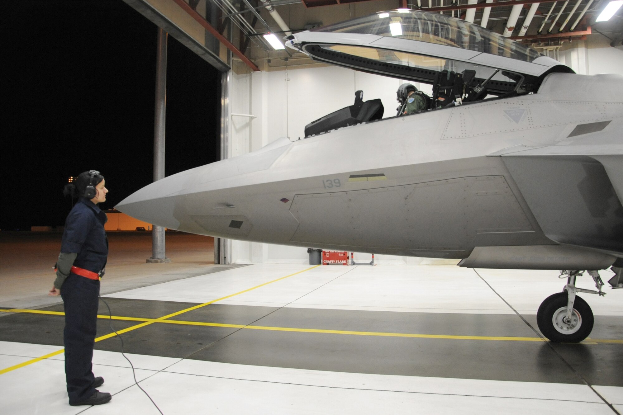 Joint Base Elmendorf-Richardson, Alaska - Airman 1st Class Jennifer Craig, 90th Aircraft Maintenance Unit, left, and Australian Maj. Matthew Harper, 90th Fighter Squadron pilot prepare an F-22 for departure to Tyndall Air Force Base, Fla.,
Oct. 30. (U.S. Air Force photo/Senior Airman Cynthia Spalding)