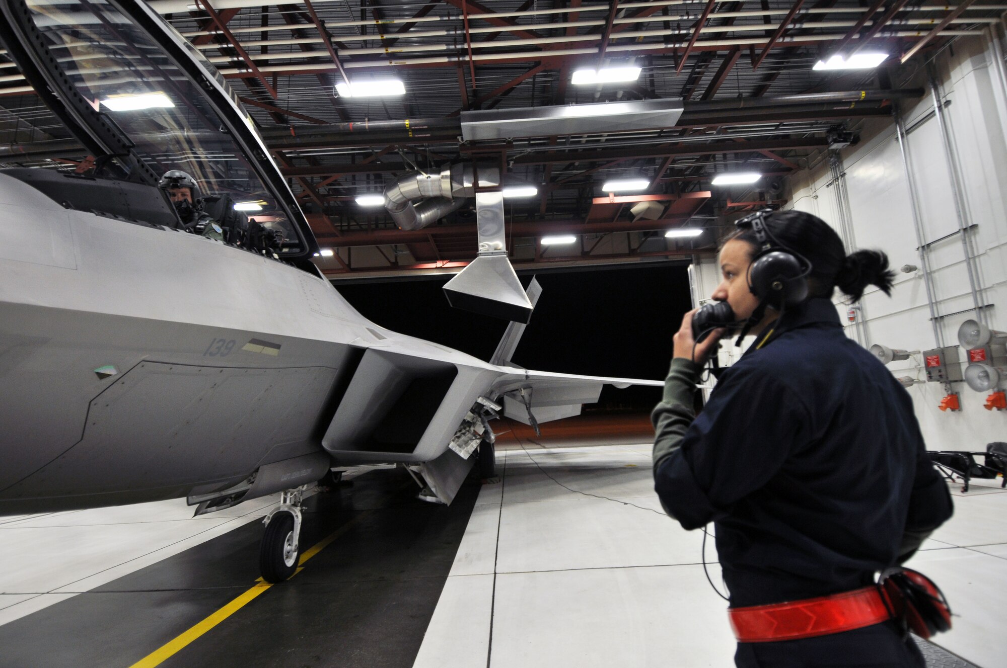 Joint Base Elmendorf-Richardson, Alaska - Airman 1st Class Jennifer Craig, 90th Aircraft Maintenance Unit, left, and Australian Maj. Matthew Harper, 90th Fighter Squadron pilot prepare an F-22 for departure to Tyndall Air Force Base, Fla., Oct.
30. (U.S. Air Force photo/Senior Airman Cynthia Spalding)