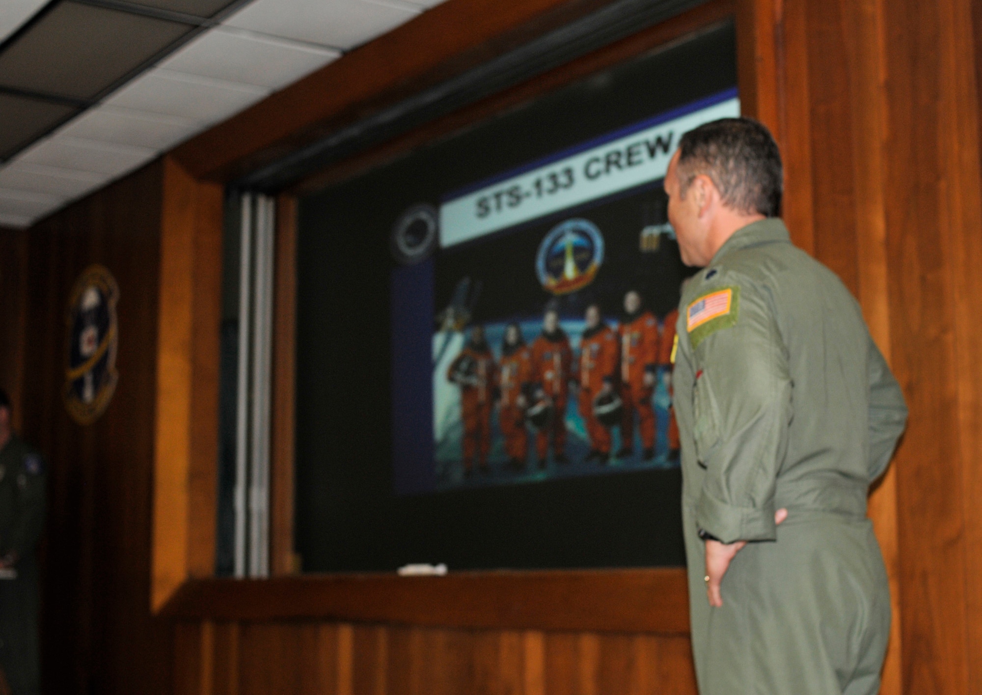 PATRICK AIR FORCE BASE, Fla. - Air Force Lt. Col. Lars Ulissey, 45th Space Wing Chief Bioastronautics, Det. 3, Medical Division, briefs nearly 100 servicemembers from all five branches during the Shuttle Joint Task Force in briefing, at the 301st Rescue Squadron here Nov. 2 to prepare those who are here supporting the emergency portion of the space shuttle Discovery launch Nov. 5. It's the last launch of Discovery and the third to the last space shuttle launch.  (U.S. Air Force photo/Capt. Cathleen Snow)