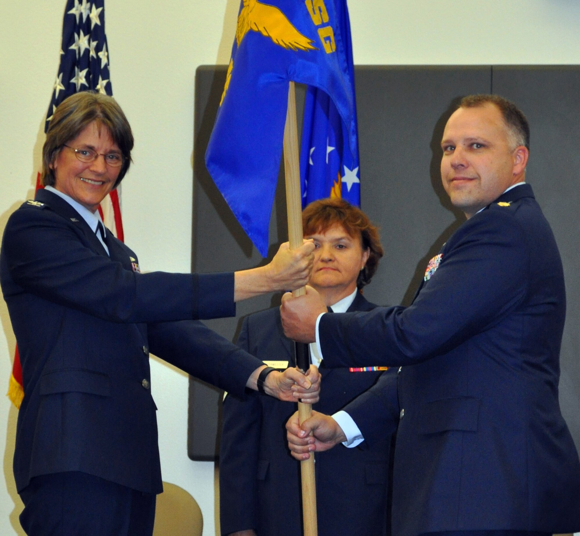 TRAVIS AIR FORCE BASE, Calif. - With the traditional passing of a flag, Maj. Travis Hansen assumed command of the 45th Aerial Port Squadron at Travis Air Force Base Oct. 3, 2010. Maj. Hansen accepted the squadron flag, and with it, command of the unit, from Col. Nancy Brooks, 349th Mission Support Group commander during the unit training assembly weekend.  With an assumption of command, the former
command has already left the squadron for another position. Maj. Cary
Simpson accepted a position with the readiness team in the 349th Logistics
Readiness Flight. Maj. Hansen joins the 349th Air Mobility Wing from his
last assignment at Hill AFB, Utah, where he still works as a civilian. (U.S.
Air Force photo/Senior Master Sgt. Ellen L. Hatfield)