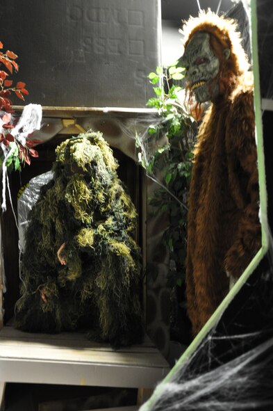 Airman 1st Class Randal Rising and Senior Airman Frederick Johnson, both from 90th Security Forces Squadron, prepare for their roles in the haunted house at the Fall Hall Community Center on Oct. 30. (U.S. Air Force photo by Airman 1st Class Dan Gage)