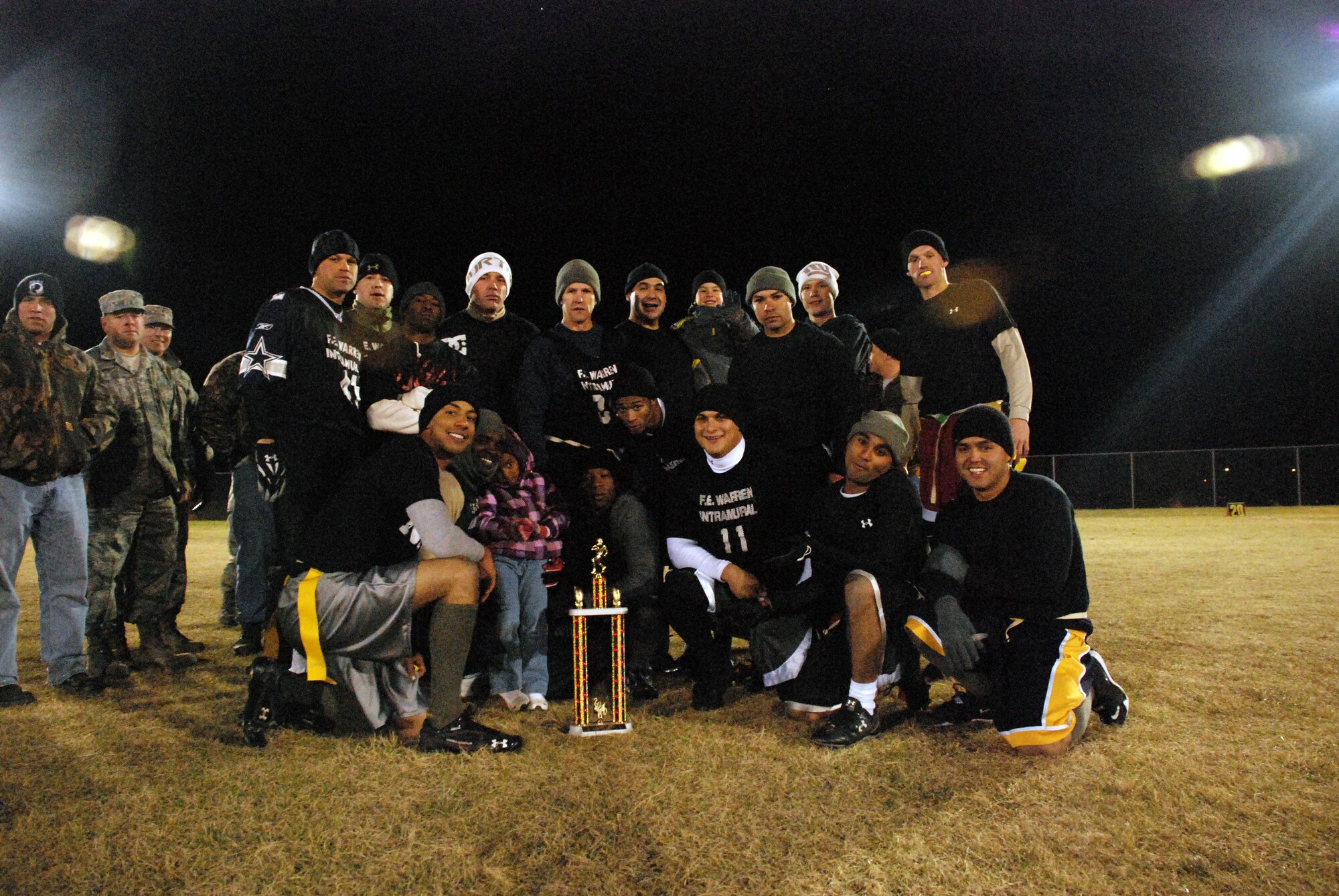 Members of the 90th Maintenance Group’s flag football team pose for a photo with the trophy for the F. E. Warren base football  intramural championship. The team finished an undefeated season with a 22-0 victory over the 90th Security Forces Group’s team at the softball fields on Oct. 27. (U.S. Air Force photo by Airman 1st Class Dan Gage)