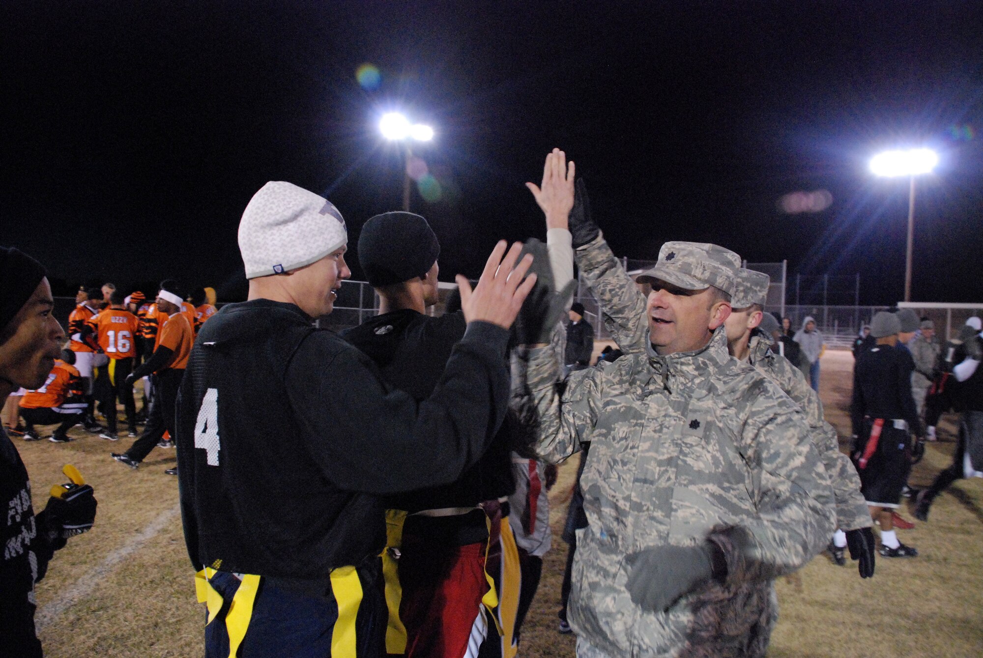 Members of the 90th Maintenance Group receive congratulations from Lt. Col. Trevor Flint, 90th Missile Maintenance Squadron commander, after their victory in the base football intramural championship Oct. 27
(U.S. Air Force photo by Airman 1st Class Dan Gage)