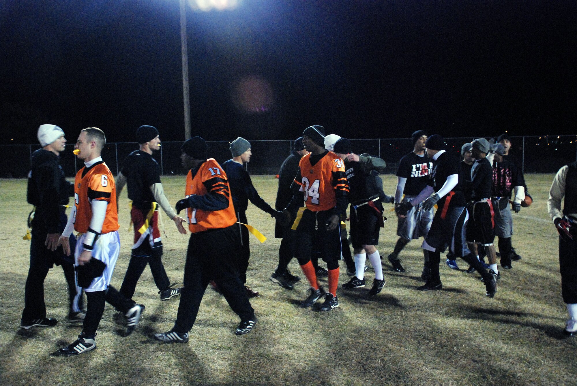 Team members from 90th Security Forces Group and 90th Maintenance Group show good sportsmanship after the base football intramural championship on Oct. 27. (U.S. Air Force photo by Airman 1st Class Dan Gage)