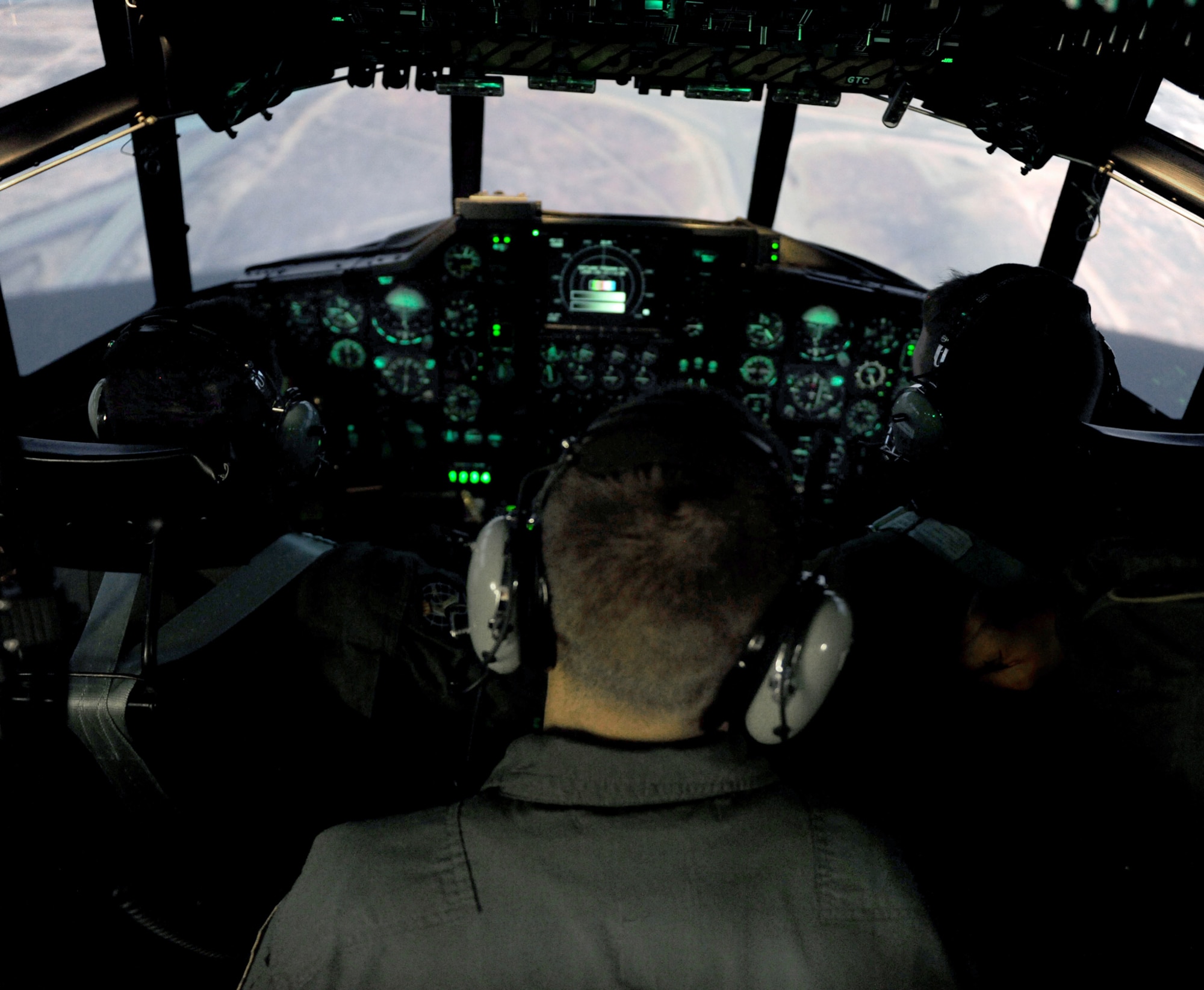 Two pilots and a flight engineer fly inside the C-130 Hercules simulator during training Nov. 1, 2010, at Moody Air Force Base, Ga. Pilots, navigators, flight engineers and other crewmembers trained during the class as if on an actual mission. (U.S. Air Force photo/Airman 1st Class Benjamin Wiseman)