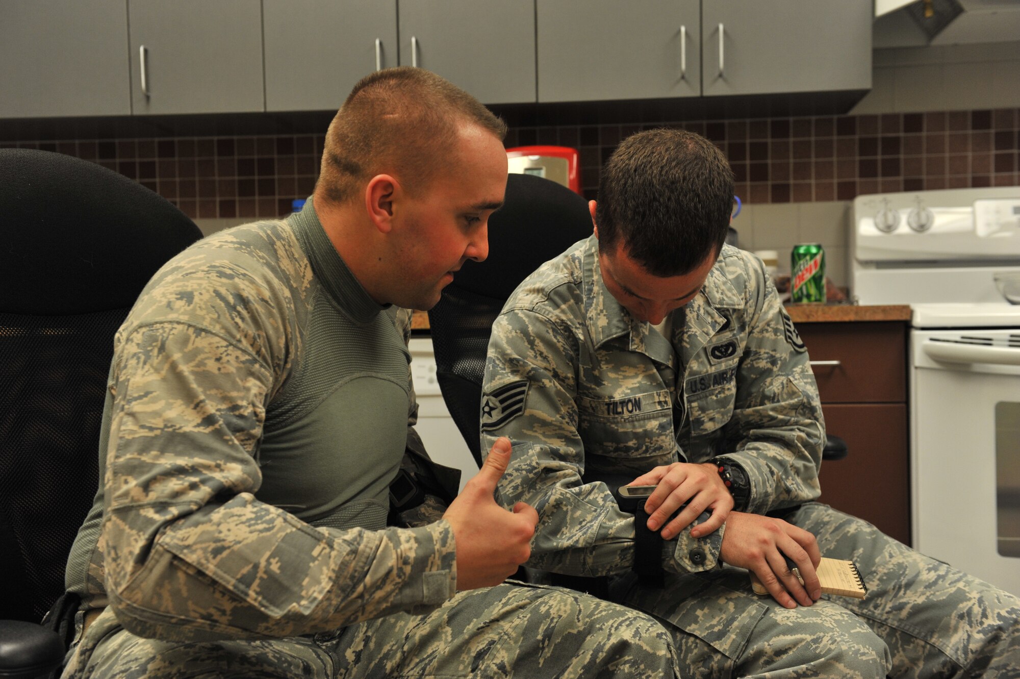 Staff Sgts Daniel Hunsinger and Tanner Tilton, 341st Civil Engineer Squadron Explosive Ordinance Disposal technicians, enter coordinates into a GPS unit before departing for a dismounted improvised explosive device night-operation exercise Oct. 26. (U.S. Air Force photo/John Turner)