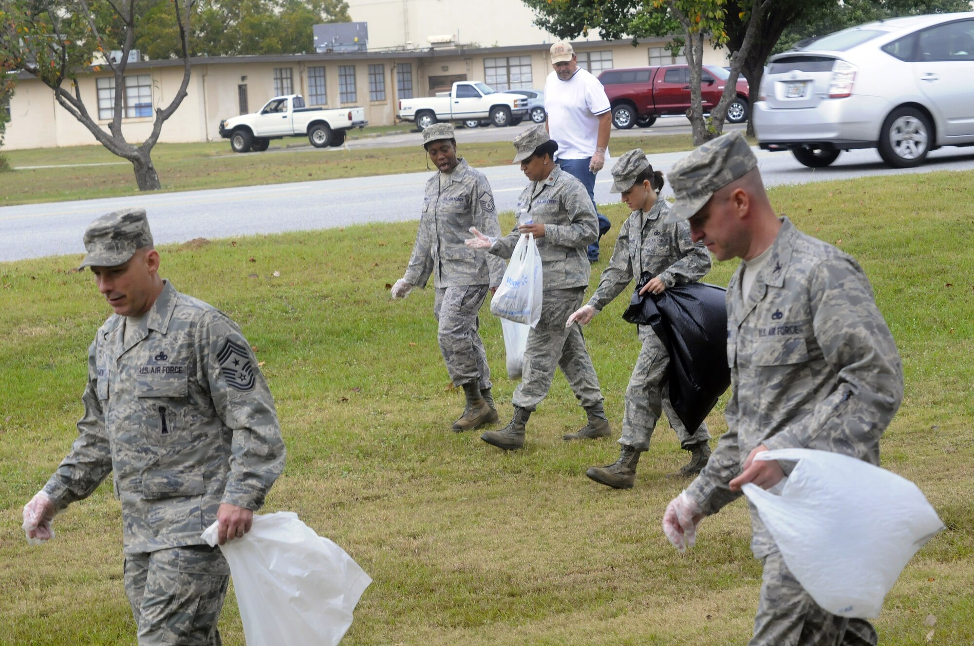 More than 100 bags of trash – about 300 pounds –  were collected Oct. 27 during the a base-wide clean up. Col. Carl Buhler (right), 78th?Air Base Wing commander, led the effort.  Organizations policed their immediate work areas, while personnel from the 78th ABW policed some of the high-traffic areas on base. Cigarette butts were the primary source of trash.  Smoking is only authorized in designated areas and butts must be placed in the proper container as they present a potential fire hazard and not doing so is littering. “It's all about taking pride in the appearance of our base and community,” said Chief Master Sgt. Patrick Bowen, Robins command chief.  U.S. Air Force photo by Sue Sapp