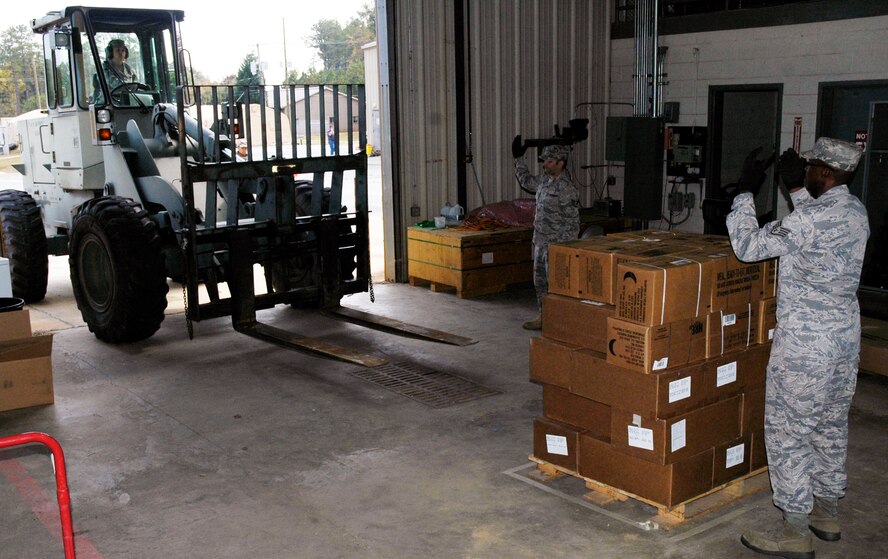 Airmen from Duke Field, Fl. prepare to load rations to feed 150 personnel onto a forklift during the Specialty Vehicle challenge of the Services Readiness Competition at Dobbins Air Reserve Base, Ga. Nov. 2-4.  Six teams from around the Air Force Reserve Command participated in the events which comprised 11 contests designed to promote skill enhancement and group cohesion amongst Air Force Services Agency personnel. (U.S. Air Force photo/Senior Airman Danielle Campbell)