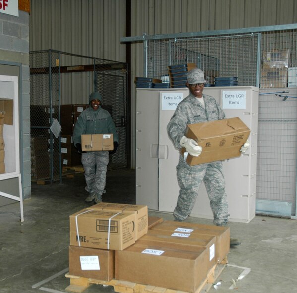 Airmen from McGuire Air Force Base, Penn. are happy to gather rations to feed 150 personnel during the Specialty Vehicle challenge of the Services Readiness Competition at Dobbins Air Reserve Base, Ga. Nov. 2-4.  Six teams from around the Air Force Reserve Command participated in the events which comprised 11 contests designed to promote skill enhancement and group cohesion amongst Air Force Services Agency personnel. (U.S. Air Force photo/Senior Airman Danielle Campbell)