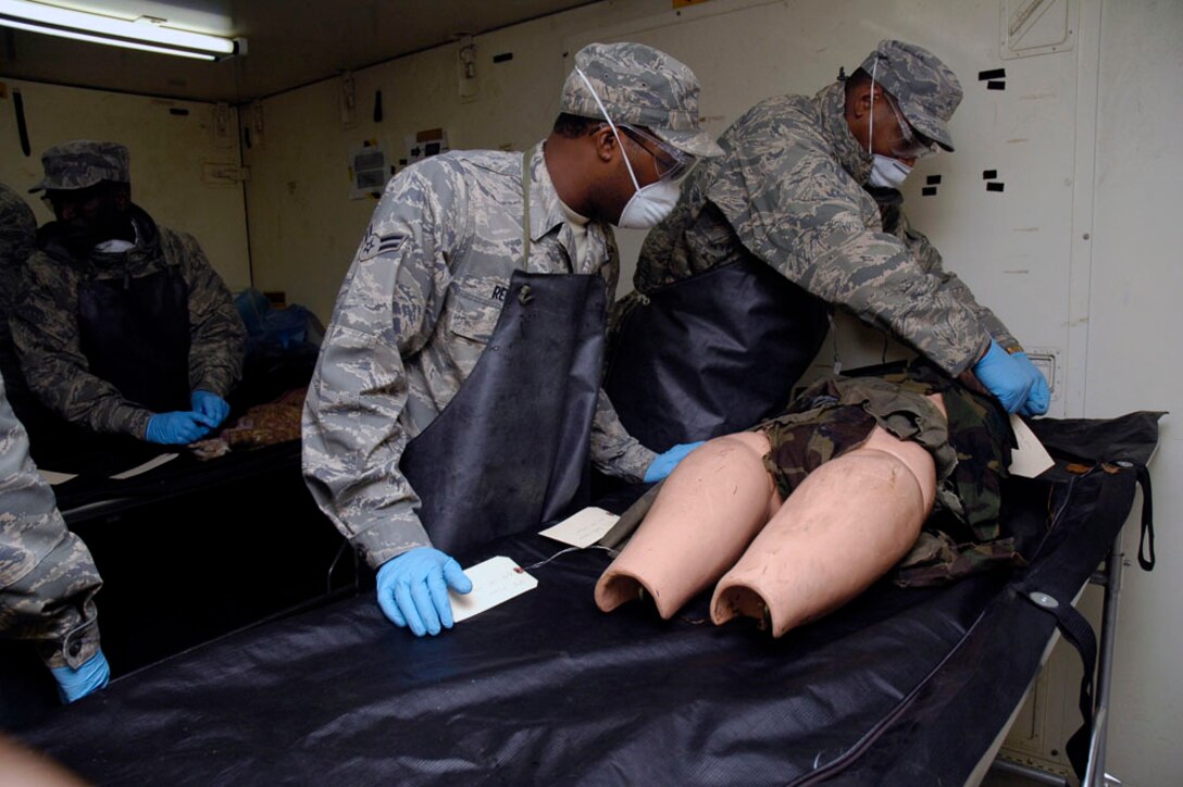 Airmen from the 94th Airlift Wing Services Squadron, Dobbins Air Reserve Base, Ga. gather at a mortuary collection point to process remains after completing the search and relief portion of the Services Readiness Competition that took place at Dobbins Nov. 2-4.  Five teams from around the Air Force Reserve Command gathered to participate in this challenge that comprised 11 events designed to promote skill enhancement and group cohesion amongst Air Force Services Agency personnel. (U.S. Air Force photo/Senior Airman Danielle Campbell)