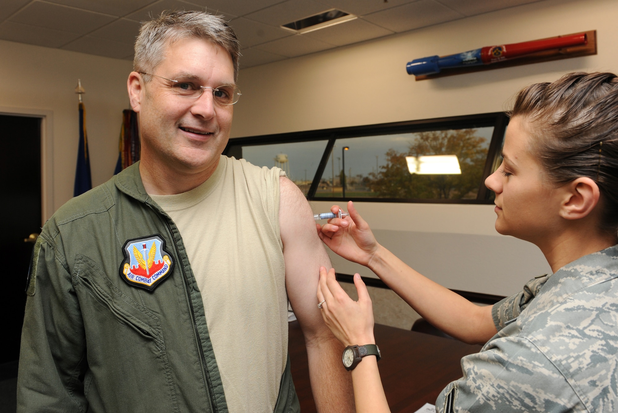MOUNTAIN HOME AIR FORCE BASE, Idaho -- Col. Ron Buckley, 366th Fighter Wing commander, receives a flu shot from Airman 1st Class Lora Splain, 366th Medical Operations Squadron, in building 512 Oct. 29. There will be a flu shot line held on Nov. 5 and Nov. 8 from 8 a.m. to 3 p.m. at the base theater. Flu shots are mandatory for all active duty personnel. (U.S. Air Force photo by Senior Airman Debbie Lockhart)