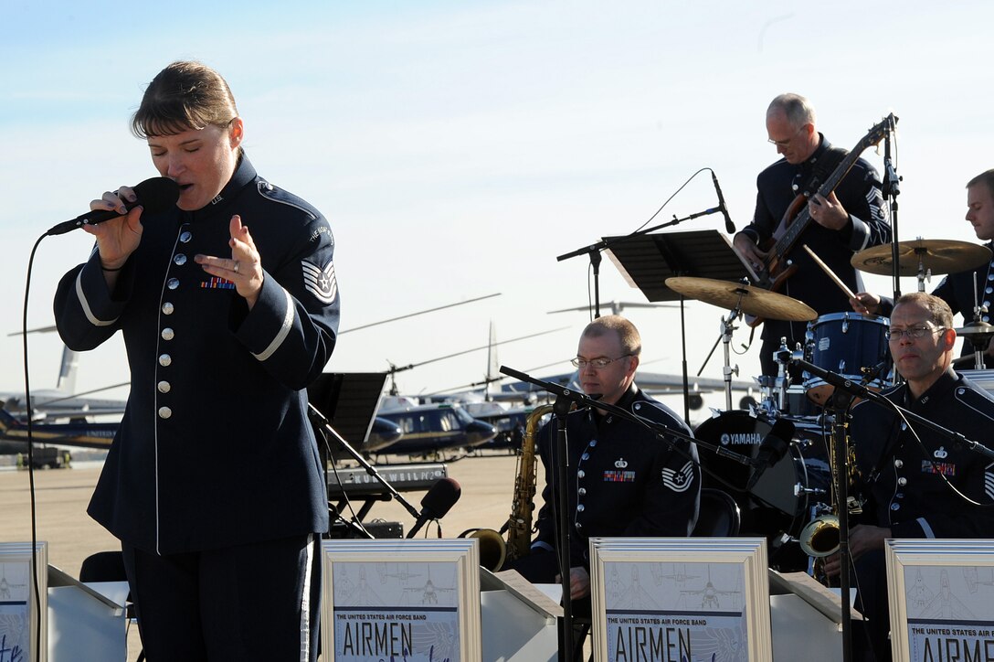 Technical Sgt. Paige Martin, vocalist for Airmen of Note as part of the Air Force Band, performs a song during the 11th Wing commander's call on the Joint Base Andrews flightline Nov 2. The commander's call highlighted the unique assets of the 11th Wing to its members after the recent mission move, including the 1st Helicopter Squadron, the Air Force Honor Guard, and the Air Force Band. (U.S. Air Force photo by Senior Airman Melissa Brownstein)