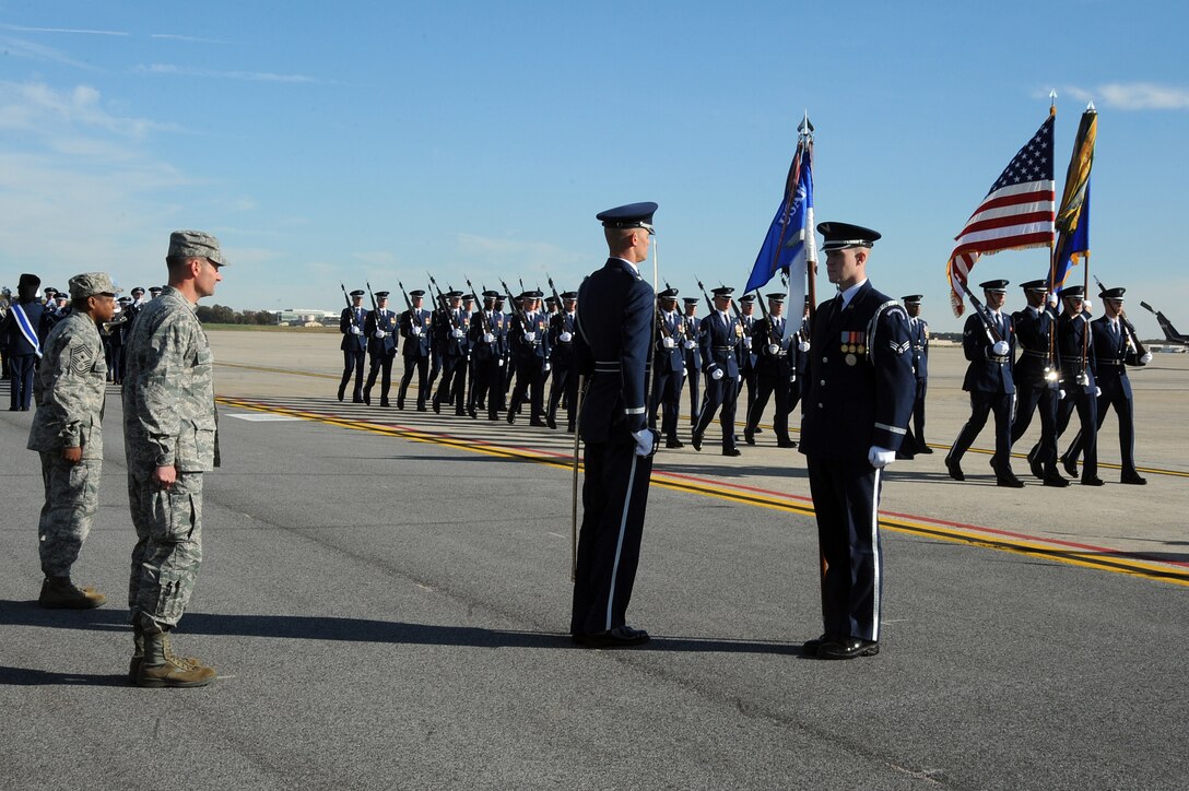 Members of the Air Force Honor Guard perform the Presentation of Command for Col. Ken Rizer, 11th Wing commander and Chief Master Sgt. Anthony Brinkley, 11th Wing command chief, during the 11th Wing commander's call on the Joint Base Andrews flightline Nov 2.  The commander's call highlighted the unique assets of the 11 WG through demonstrations by the 1st Helicopter Squadron, the Air Force Honor Guard, and the Air Force Band.  (U.S. Air Force photo by Senior Airman Melissa V. Brownstein)