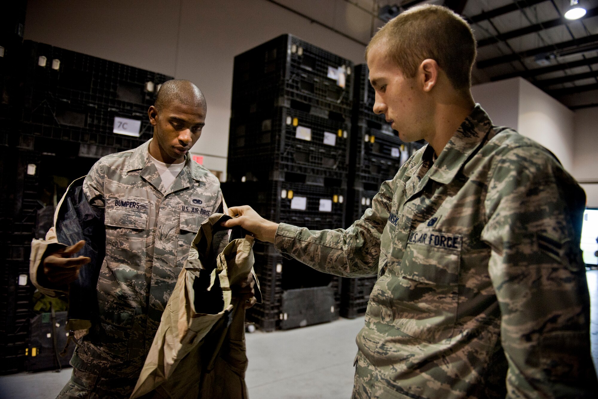 MOODY AIR FORCE BASE, Ga. -- Airman 1st Class Jeremie Bumpers (left), 23rd Equipment Maintenance Squadron aircraft-structural maintenance apprentice, receives individual protection equipment from Airman 1st Class Matthew Ciekanski, 23rd Logistics Readiness Squadron material management apprentice, during a mass-equipment issue Nov. 4. The 23rd LRS IPE flight dedicated two days to ensure personnel had the proper training gear needed for the upcoming operational readiness exercise. (U.S. Air Force photo/Senior Airman Jamal D. Sutter)(RELEASED)