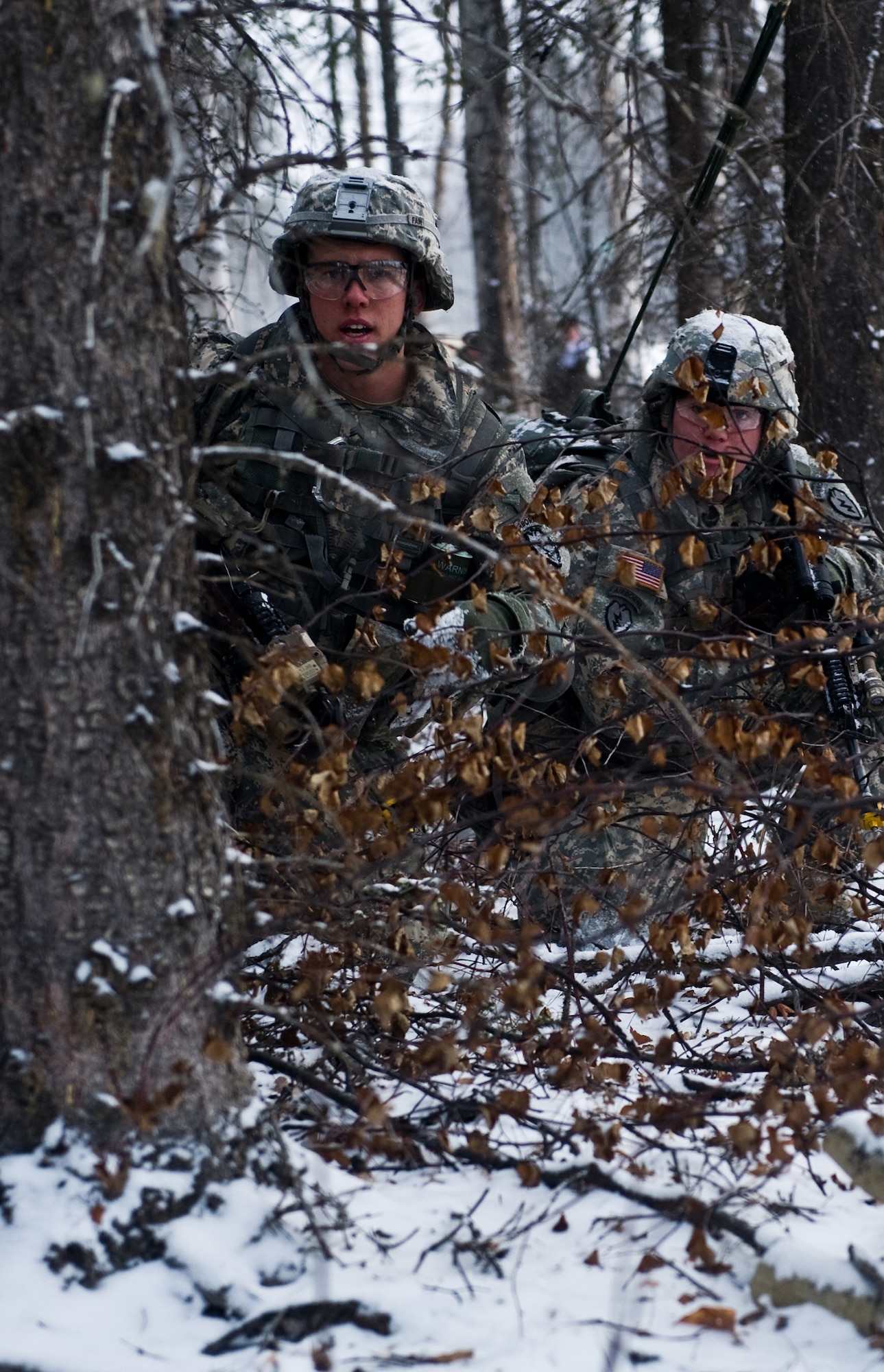 FORT GREELY, Alaska ? Sgt. Raymond Fain, left, and his teamate both of the 2nd Platoon, C Company, 1st Battalion, 501st Infantry Regiment (Airborne) take cover while under ?enemy fire? during a training exercise Oct. 29. Soldiers from the 501st IR participated in field-training exercises, with the first elements arriving to Donnelly Training Area, Fort Greely, Alaska Oct. 14 and the last of the Soldiers scheduled to leave Nov. 10. (U.S. Air Force photo/Airman 1st Class Christopher Gross)