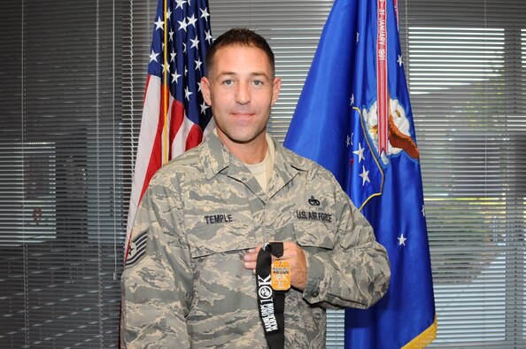 McGHEE TYSON AIR NATIONAL GUARD BASE, Tenn. - Tech. Sgt. John Temple displays the medal he received for competing in the 35th Annual Marine Corps Marathon, Nov. 2, 2010, at The I.G. Brown Air National Guard Training and Education Center here.  (U.S. Air Force photo by Master Sgt. Kurt Skoglund/Released)