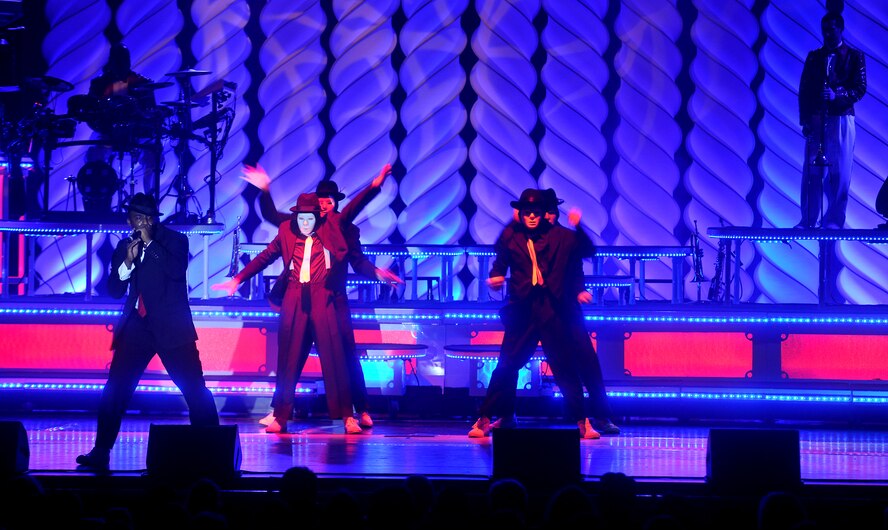 VALDOSTA, Ga. -- Senior Airman Adam Rideaux, Tops In Blue vocalist, performs beat box renditions of popular Michael Jackson songs while members break dance in the background at the Valdosta Performing Arts Center Nov. 2.  The theme for this year’s Tops In Blue is “We Believe” and is a salute to the ideals we believe in as Americans. (U.S. Air Force photo/Airman 1st Class Joshua Green)(RELEASED)
