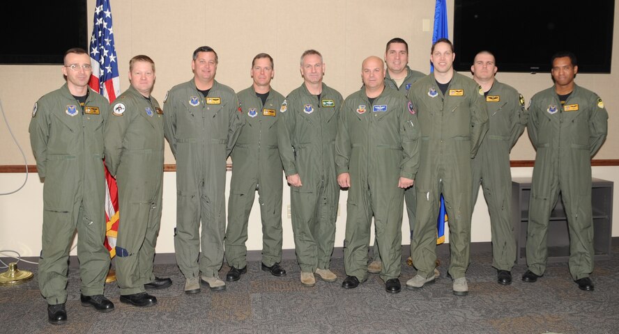 BARKSDALE AIR FORCE BASE, La. -- Col. Tim Fay, 2nd Bomb Wing commander, (center), congratulates nine officers for their outstanding performance, Oct. 29. From left to right the crewmembers are from the 11th and 93rd Bomb squadrons Maj. Jonathon Beavers, Maj. Timothy Pierce, Maj. Samuel Smith, Lt. Col. Chris Jorgensen, Maj. Tim Bell, Capt. Jesse Hildebrand, Capt. David Pabst, Capt. Jeffery Rogers and Capt. Mike Matthews.  Both instructors were presented a B-52 instructor coin. Each coin is numbered and unique to the instructor it belongs to. Seven crewmembers were recognized for flying 2,000 hours in the B-52. It is considered a significant milestone in a flying career with most flyers averaging around 1,500 hours by the time they pin on the rank of major. (U.S. Air Force photo/Senior Airman Alexandra M. Boutte)