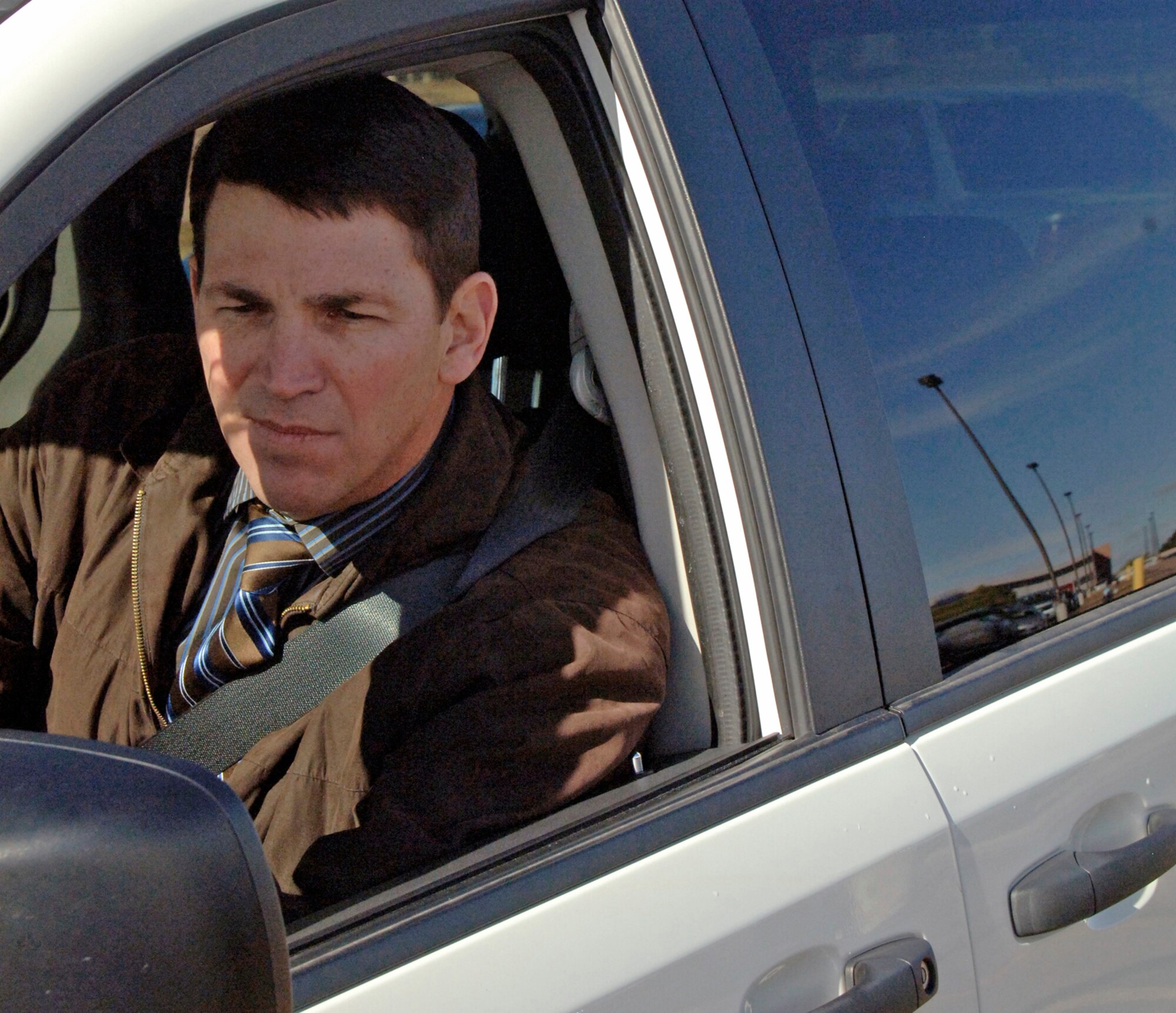 Paul Pabich, the primary driver for his neighborhood commuter van pool, maneuvers through an on-base parking lot Nov. 1, 2010, at Schriever Air Force Base, Colo. Mr. Pabich shares the van pool with five of his neighbors who also work on base. (U.S. Air Force photo/Scott Prater)
