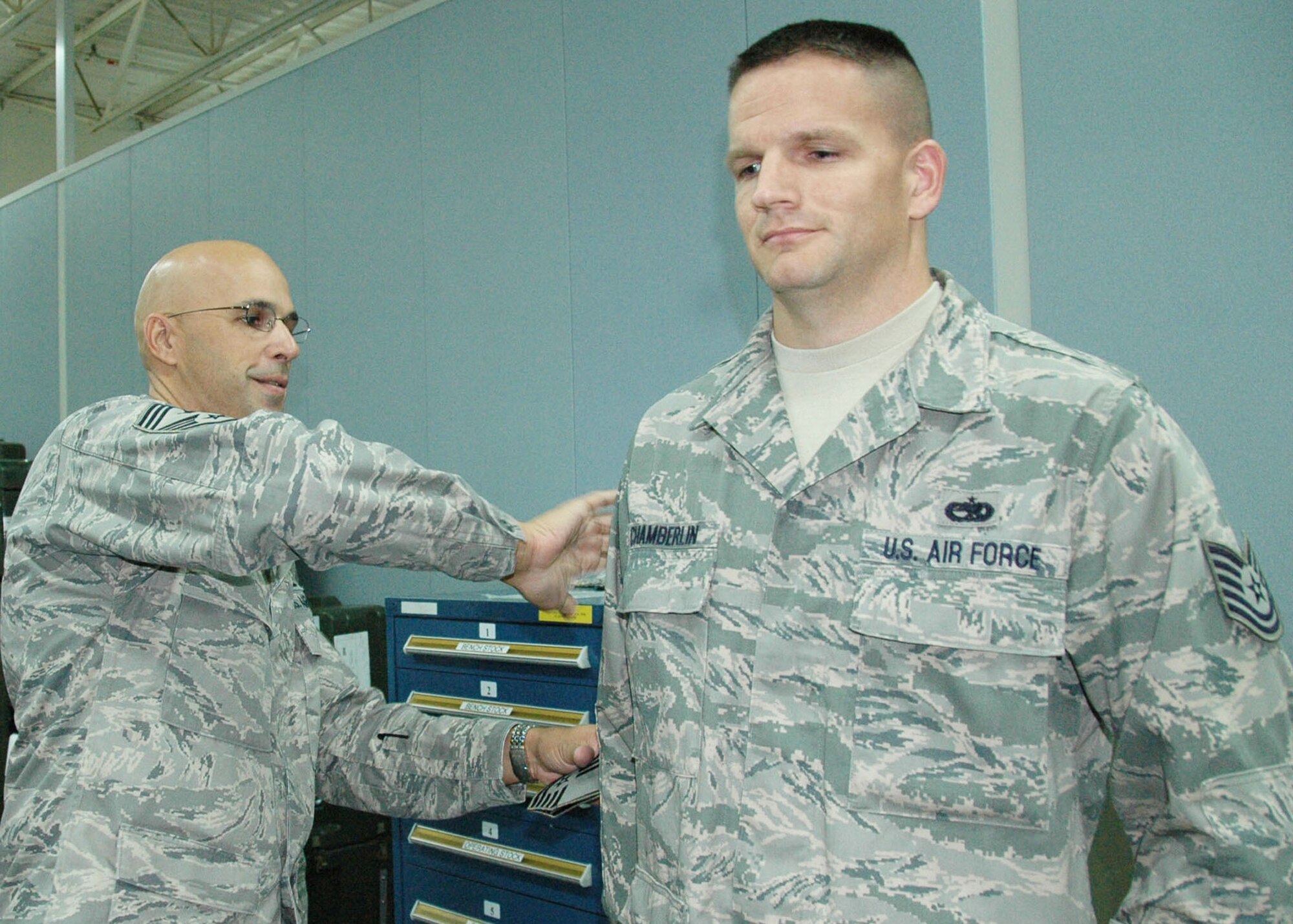 Technical Sgt.  Wayne Chamberlin, 919th Maintenance Squadron, stands at attention as Chief Master Sgt.  Michael Klausutis, 919th Special Operations Wing command chief, “tacks on” his new stripes during a surprise promotion ceremony Oct. 2 at Duke Field.   Sergeant Chamberlin was one of eight Duke Field reservists awarded immediate Promotion Enhancement Program promotions during the wing’s October unit training assembly. The PEP is a commander’s  program designed to promote outstanding and well-deserving Air Force Reserve Airmen one grade above the authorized grade for their position.  Only those Airmen who show outstanding potential are considered based on a demonstrated ability to serve in the next higher grade.  (U.S. Air Force photo/Dan Neely)