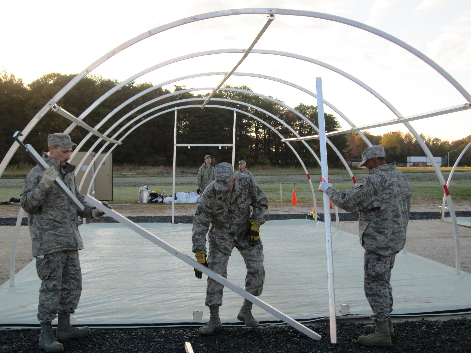 L-R Senior Master Sgt. Stanley F. Dulski, Jr., Tech. Sgt. John D. Trommer  and Airman 1st Class John W. Harper, II, members of the Maryland Air National Guard's 175th Civil Engineer Squadron, assemble an Alaskan Tent  at Warfield Air National Guard Base in Baltimore, Md., Oct. 30, 2010. The work is in preparation for approximately 300 National Guard members who will be housed at the base to participate Exercise Vigilant Guard. (U.S. Air Force photo by Lt. Col. Steven H. Benden/Released)

