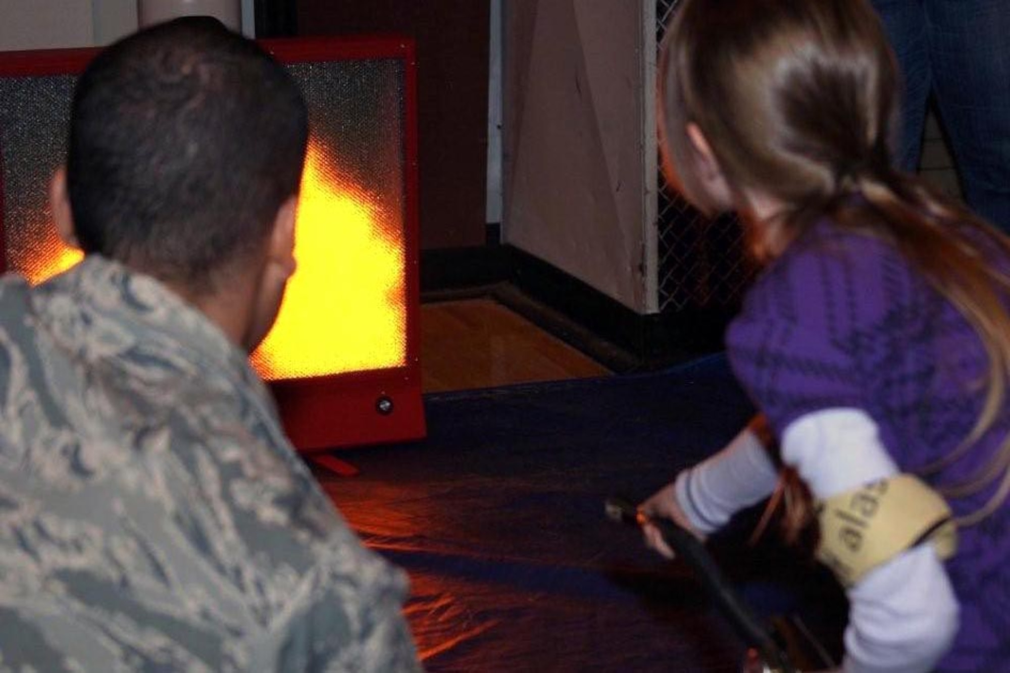 Firefighters from the Joint Base Elmendorf-Richardson Fire Department show the Girl Scouts how to properly put out a fire with a fire extinguisher during the Trailblazer Boot Camp Oct. 29. (U.S. Army photos/Spc. Tamika Dillard)
