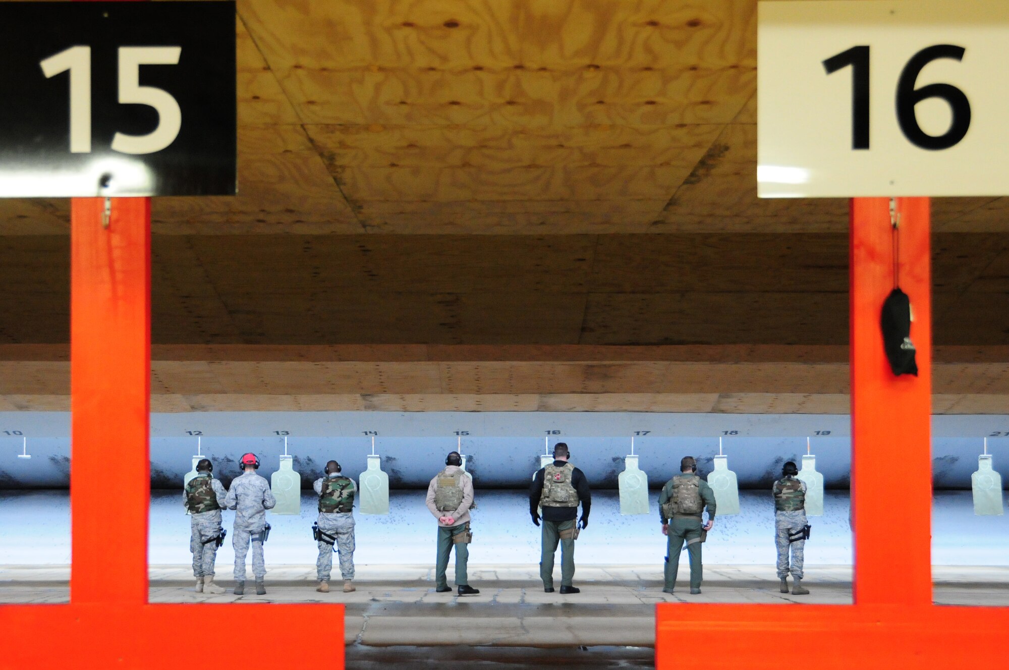 ROYAL AIR FORCE FELTWELL, England – Members from the 56th Rescue Squadron and members from the 48th Operational Support Squadron prepare to shoot their M-9 Berettas at posted targets Nov. 2. The new firing range can serve up to 21 shooters at a time. (U.S. Air Force photo/Airman 1st Class Erin Zabarnick) 