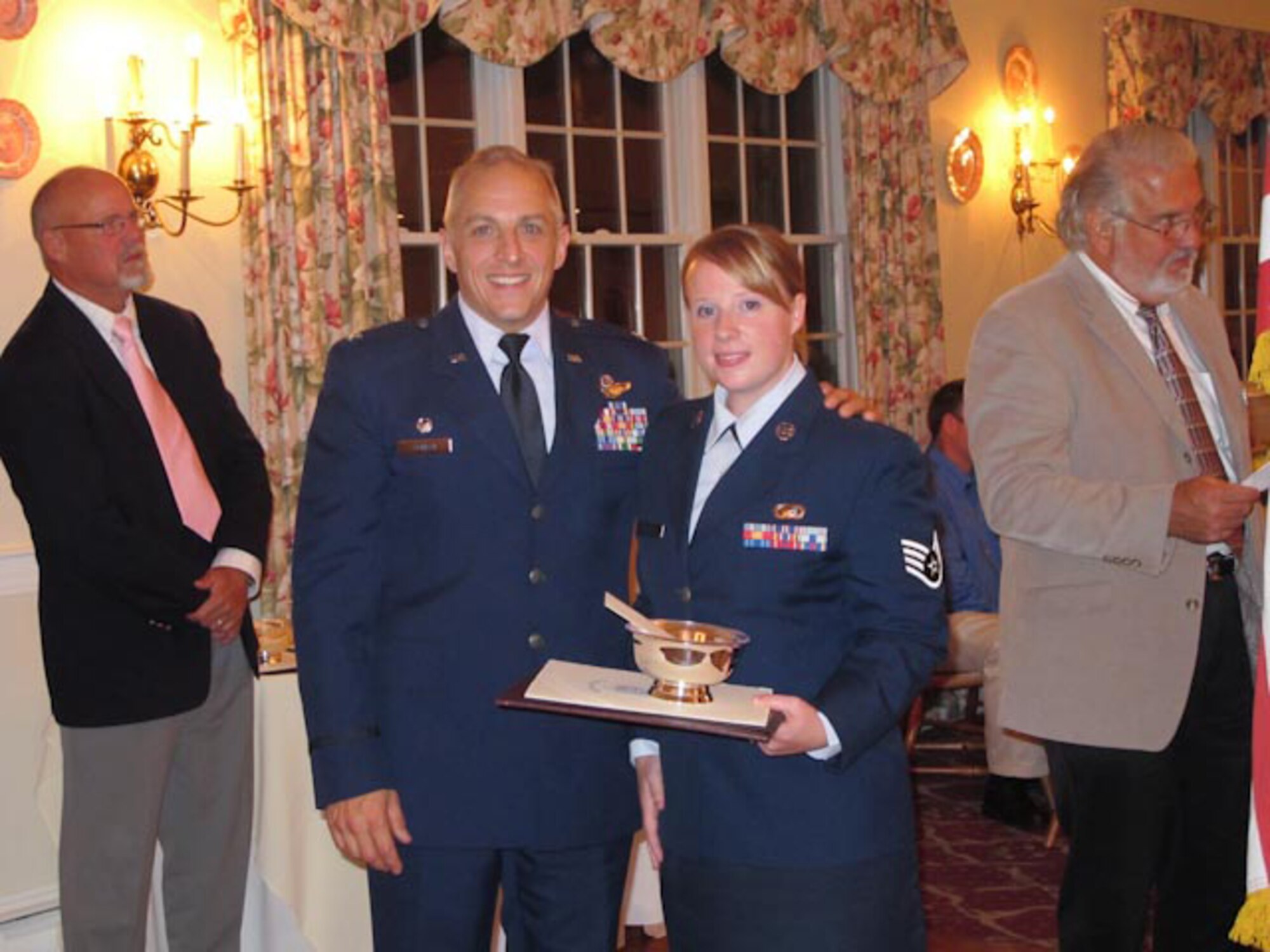 Staff Sgt. Kerri Cole (right), 102nd Intelligence Wing Public Affairs photographer, was selected by Col. Anthony Schiavi (left), 102nd Intelligence Wing commander, as the Wing's Outstanding Military Individual of the Year for 2010.  Sergeant Cole received the Otis Civilian Advisory Council-sponsored award, at an Oct. 7, 2010 banquet in Falmouth, Mass.  (U.S. Air Force photo by Master Sgt. Sandra Niedzwiecki)