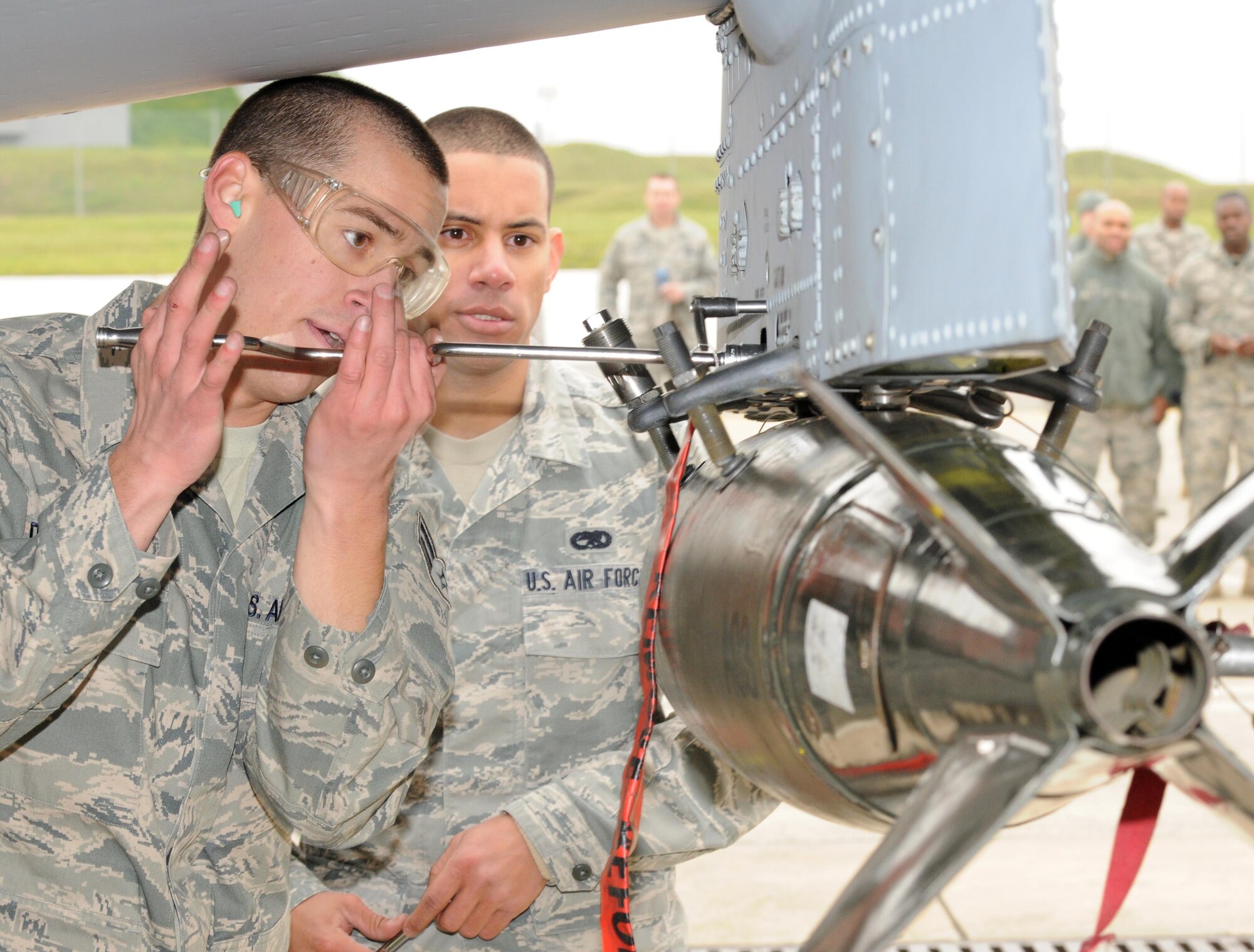 SPANGDAHLEM AIR BASE, Germany – Airman 1st Class Samuel Dipasquale, left, and Airman 1st Class Gerardo Carpio-Perez, both 52nd Aircraft Maintenance Unit weapons load crew members, install impulse cartridges for an MK-82 LD bomb on an A-10 Thunderbolt II during the load crew of the quarter competition Nov. 2. The 480th Fighter Squadron load crew competed against the 81st Fighter Squadron load crew to determine the winner that will advance to compete for load crew of the year. (U.S. Air Force photo/Airman 1st Class Matthew B. Fredericks)