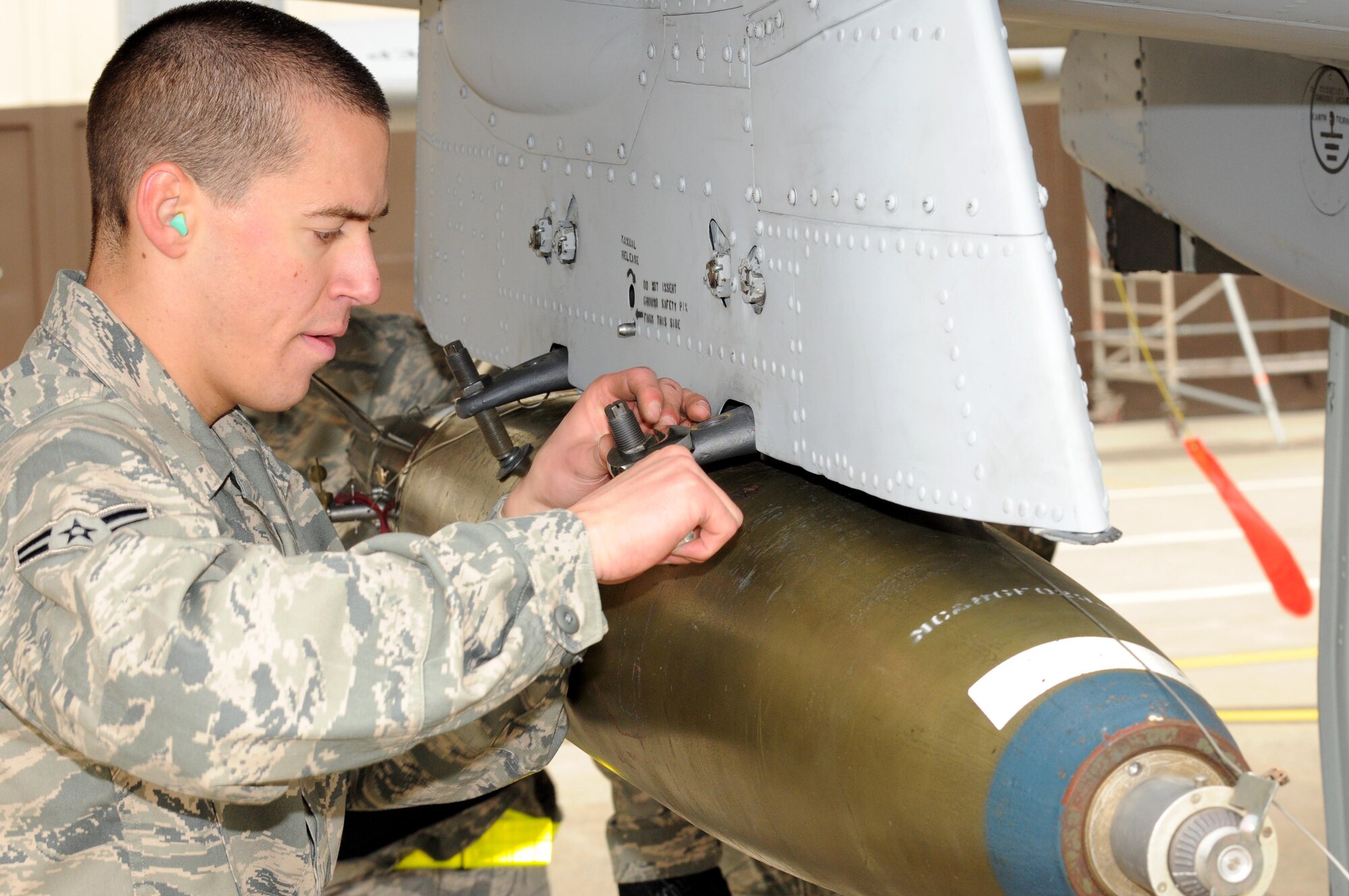 SPANGDAHLEM AIR BASE, Germany – Airman 1st Class Samuel Dipasquale, 52nd Aircraft Maintenance Squadron weapons load crew member, works on loading an MK-82 LD bomb onto the wing of an A-10 Thunderbolt II during the load crew of the quarter competition Nov. 2. The 480th Fighter Squadron load crew competed against the 81st Fighter Squadron load crew to determine the winner that will advance to compete for load crew of the year. (U.S. Air Force photo/Airman 1st Class Matthew B. Fredericks)