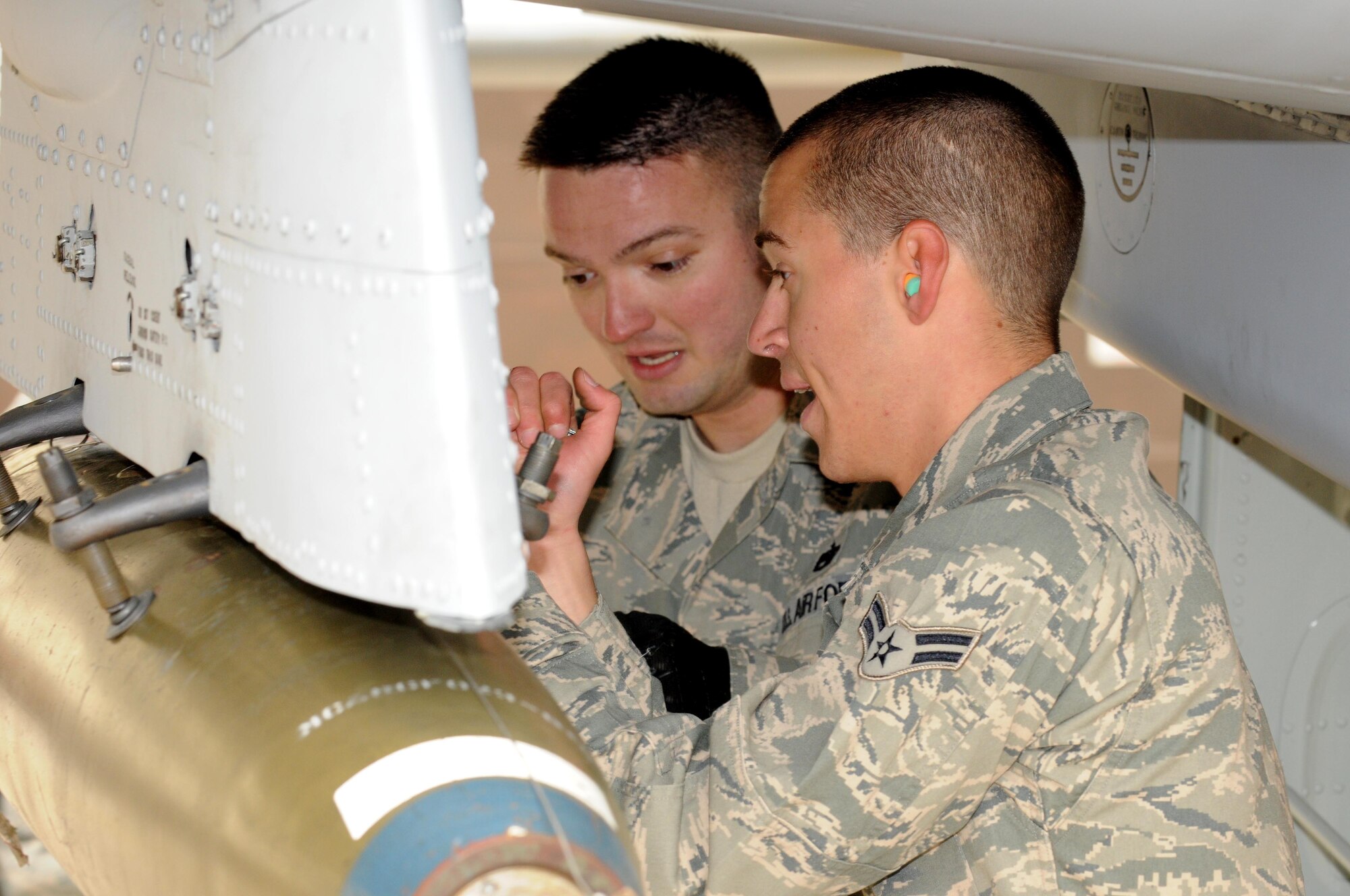 SPANGDAHLEM AIR BASE, Germany –Staff Sgt. Sean Hughes, left, and Airman 1st Class Samuel Dipasquale, both 52nd Aircraft Maintenance Squadron weapons load crew members, load an MK-82 LD bomb onto an A-10 Thunderbolt II during the load crew of the quarter competition Nov. 2. The 480th Fighter Squadron load crew competed against the 81st Fighter Squadron load crew to determine the winner that will advance to compete for load crew of the year. (U.S. Air Force photo/Airman 1st Class Matthew B. Fredericks)