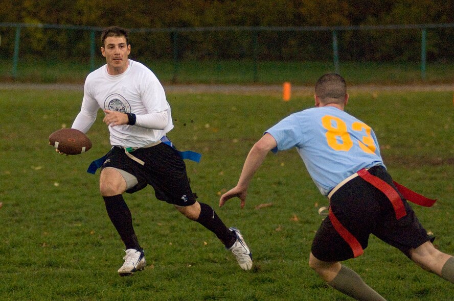 HANSCOM AIR FORCE BASE, Mass. – 1st Lt. Robert Giannini (left) looks to avoid a "tackle" during the intramural flag football championship on Oct. 28. The team from the Cyber/Netcentric Directorate, "Cyber Knights," beat the C2ISR Directorate team 28-6 to win the championship. (U.S. Air Force photo by Mark Wyatt)
