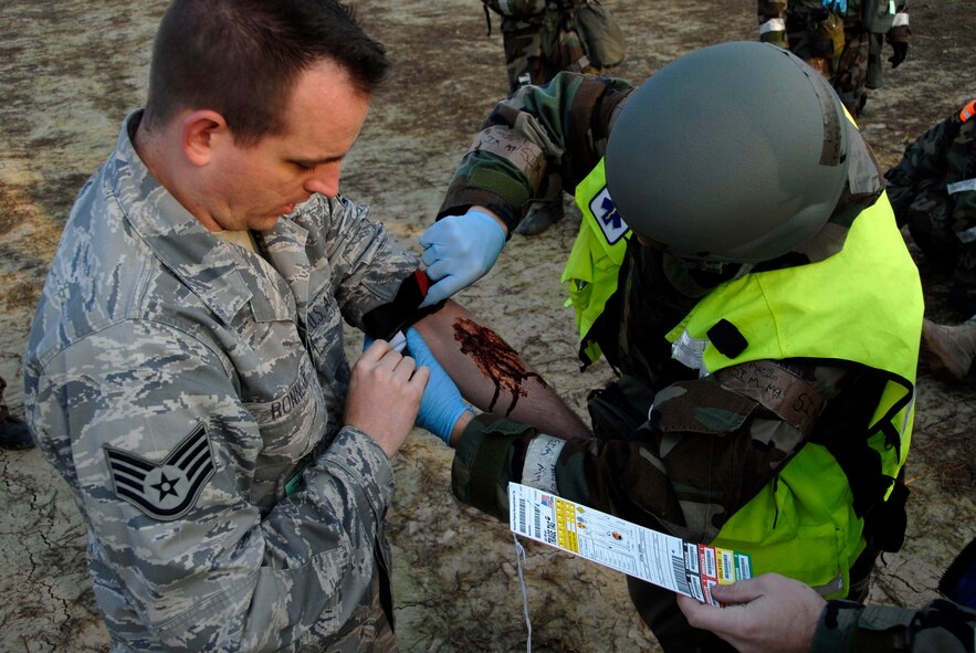 A 51st Medical Group Airman treats a "casualty" at Osan Air Base, Republic of Korea, during Beverly Midnight 10-02, Nov. 4. BM 10-02 is an exercise which allows Airmen to demonstrate their ability to complete the mission in simulated chemical environments while executing their primary duties, practicing self aid and buddy care, conducting post-attack reconnaissance and unexploded ordnance sweeps. (U.S. Air Force photo/Tech. Sgt. Stacy Foster)