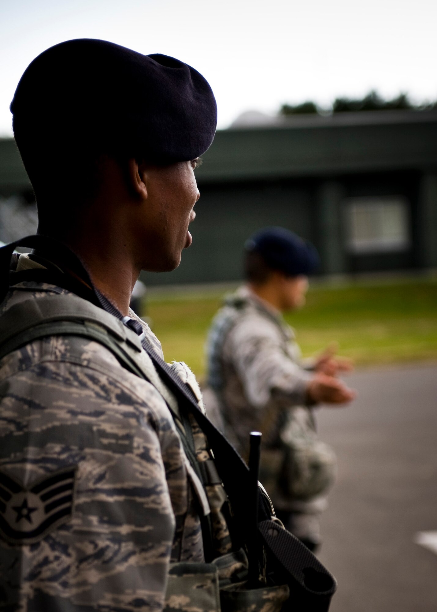 U.S. Air Force Staff Sgt. Jason Lilly and Airman 1st Class Michael Dacoron, 35th Security Forces Squadron, direct traffic at the flightline entry control point during an operational readiness exercise at Misawa Air Base, Japan, Nov. 4, 2010. The exercise gave law enforcement Airmen an opportunity to practice maintaining security of the flightline. (U.S. Air Force photo by Staff Sgt. Samuel Morse/Released)