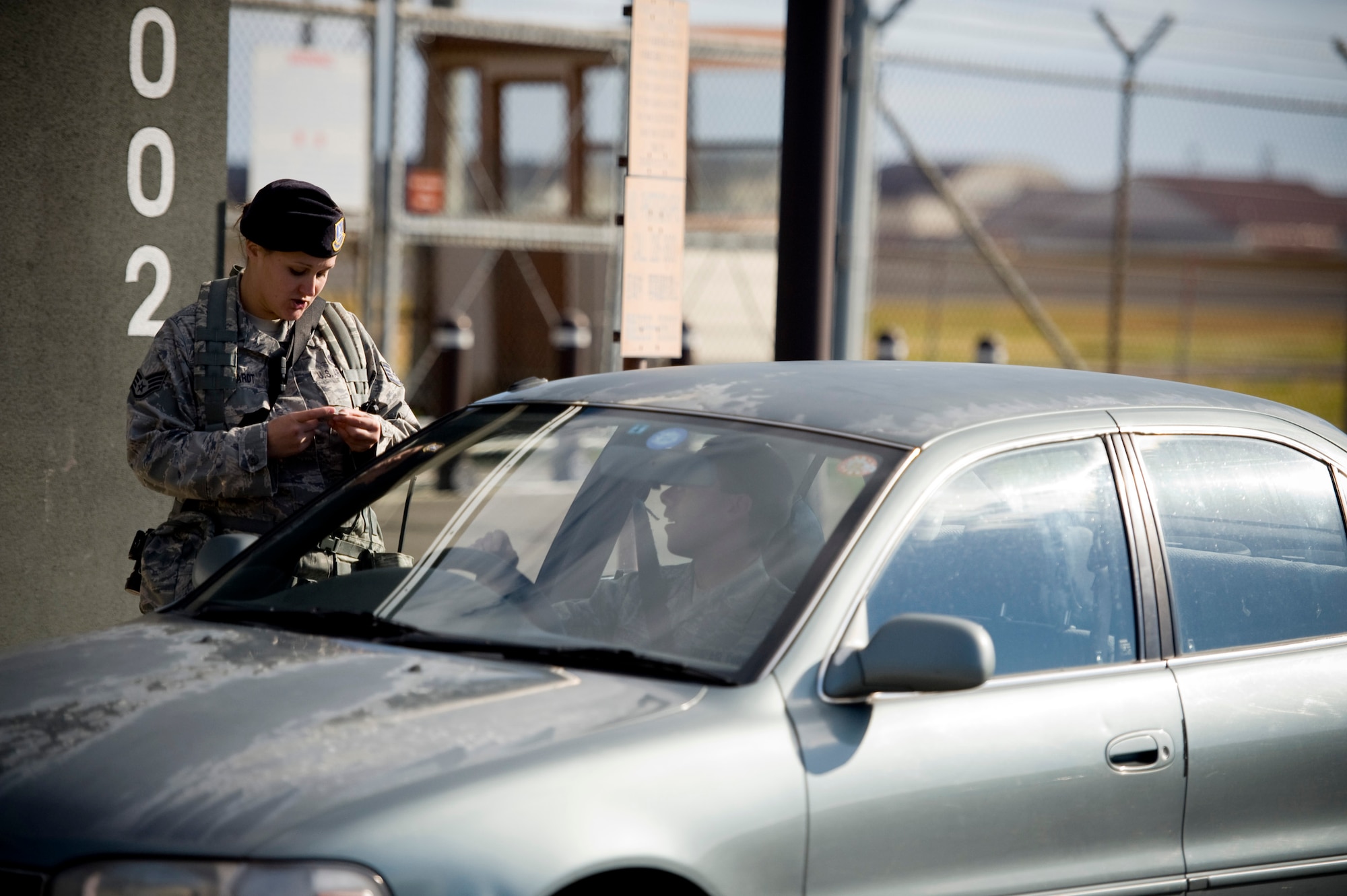U.S. Air Force Staff Sgt. Mindy Busshardt, 35th Security Forces Squadron, checks identification at the flightline entry control point, Misawa Air Base, Japan, Nov. 4, 2010. The 35 SFS placed extra security at the flightline as part of an operational readiness exercise. (U.S. Air Force photo by Staff Sgt. Samuel Morse/Released)