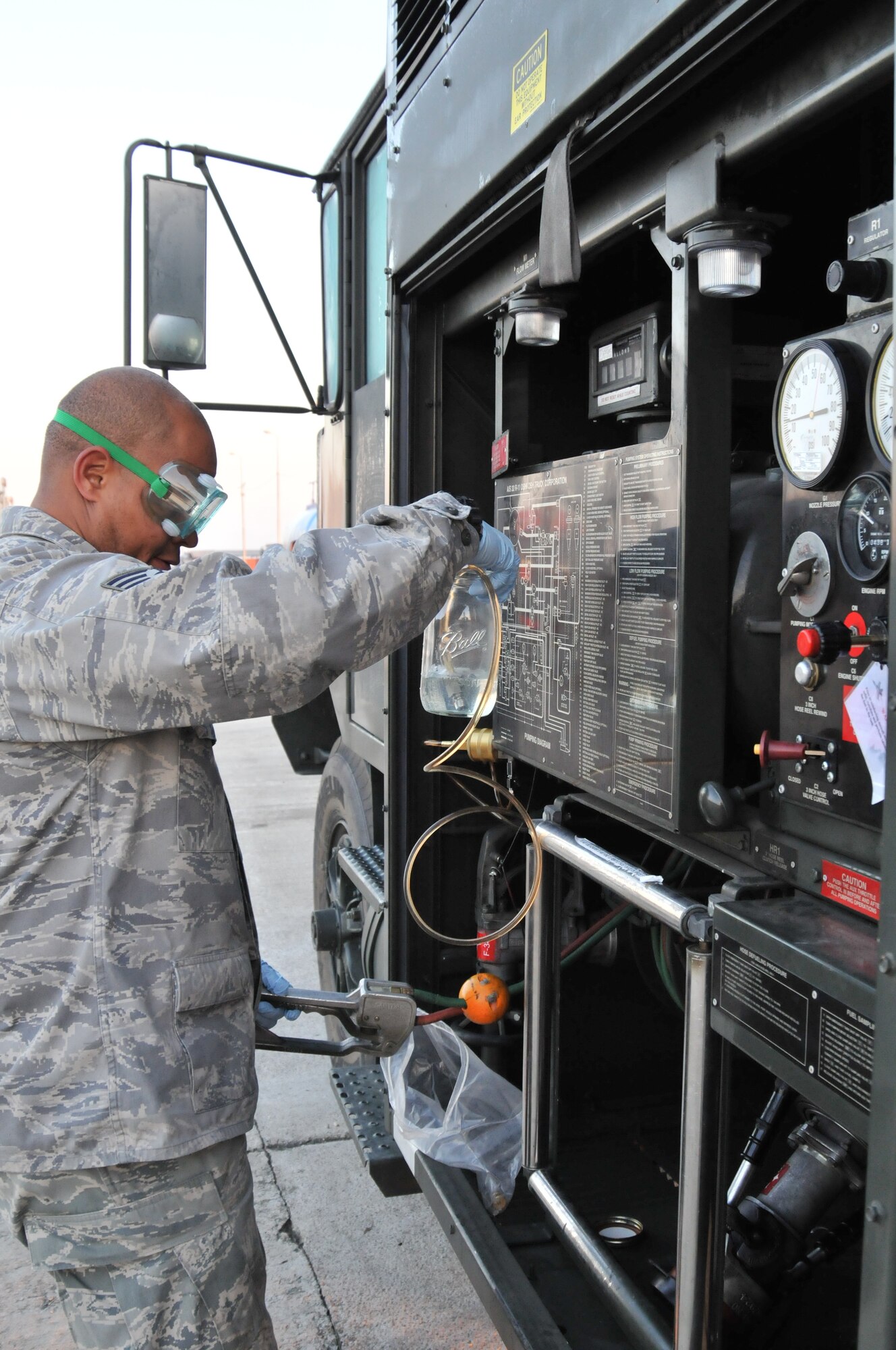 CAMPIA TURZII AIR BASE, Romania – Tech. Sgt. Christopher Conley, 48th Logistics Readiness Squadron fuels lab technician, takes a sample of aviation fuel for testing Oct. 29.  Before it can be loaded into an aircraft, the fuel must be tested for contaminants and the correct levels of protective additives. (U.S. Air Force photo/Senior Airman David Dobrydney)