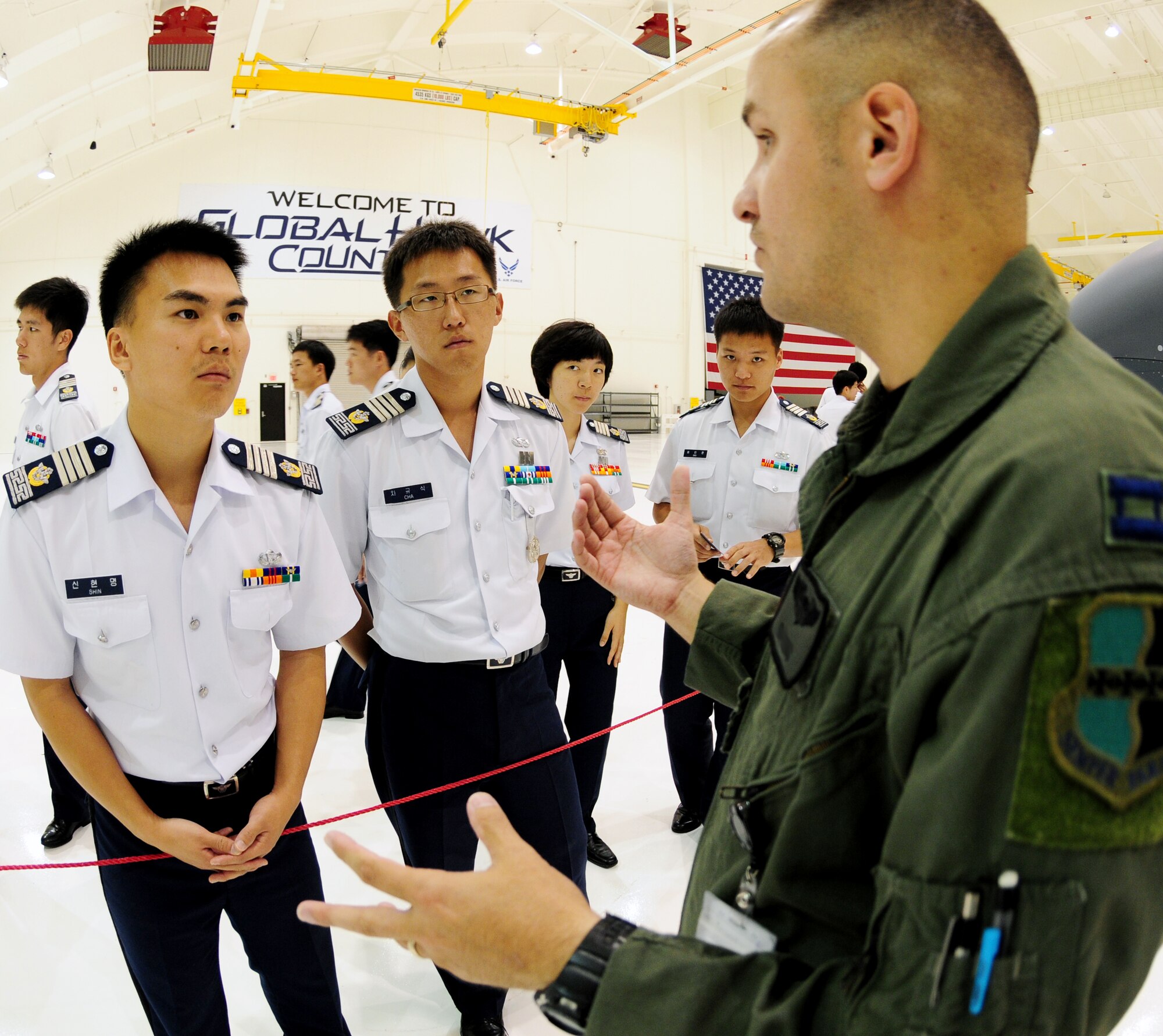 A U.S. Air Force captain from the 9th Operations Group, Detachment 3, speaks to more than 60 Republic of Korea Air Force Academy Cadets and 18 Officers about the RQ-4 Global Hawk aircraft and its unique mission at Andersen Air Force Base during a tour here Nov. 4.  The purpose of their visit here and Joint Region Marianas Naval Base Guam was to promote and strengthen the close ties between the allied nations. (U.S. Air Force photo/ Senior Airman Nichelle Anderson)