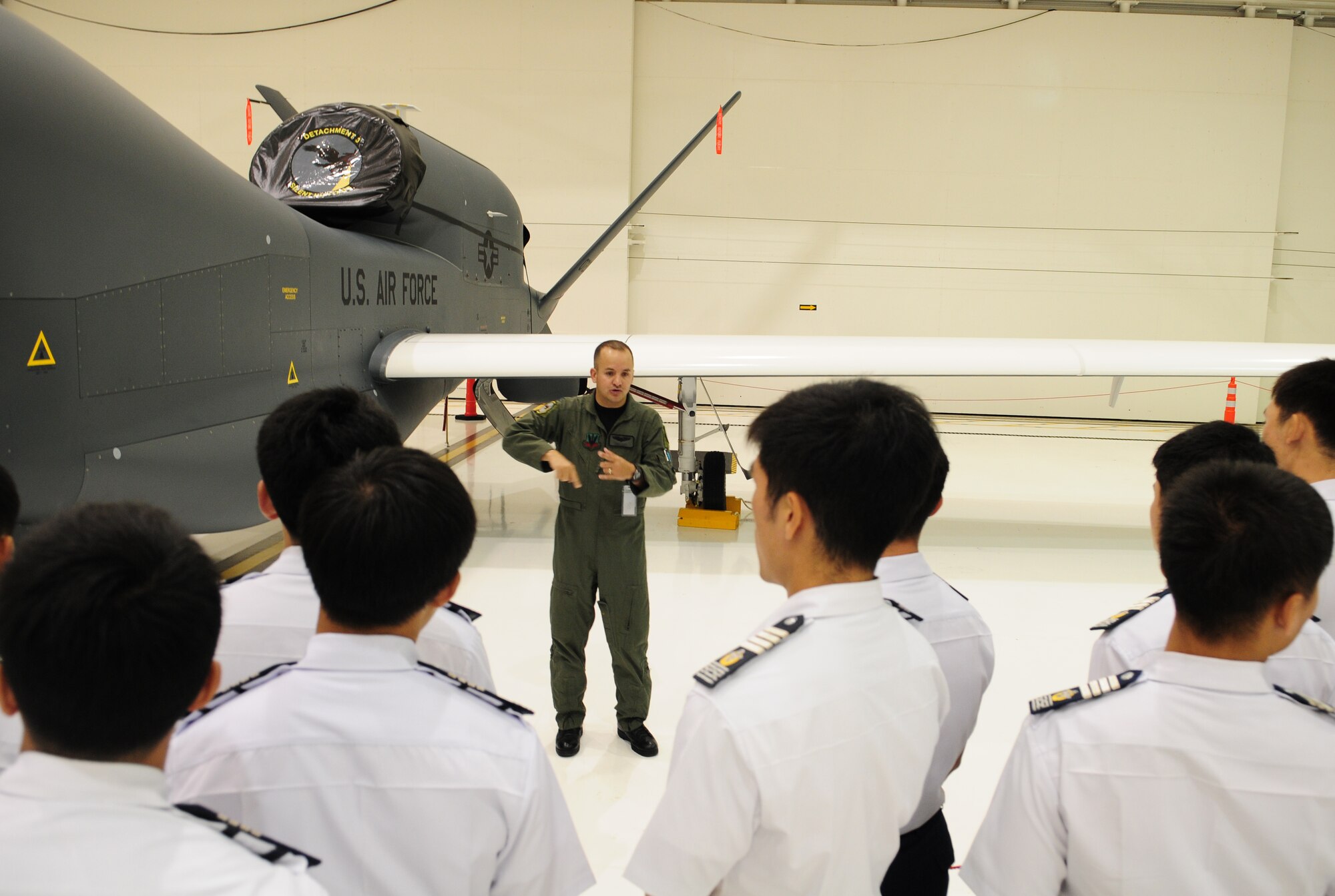 A U.S. Air Force captain from the 9th Operations Group, Detachment 3, speaks to more than 60 Republic of Korea Air Force Academy Cadets and 18 Officers about the RQ-4 Global Hawk aircraft and its unique mission at Andersen Air Force Base during a tour here Nov. 4.  The purpose of their visit here and Joint Region Marianas Naval Base Guam was to promote and strengthen the close ties between the allied nations. (U.S. Air Force photo/ Senior Airman Nichelle Anderson)