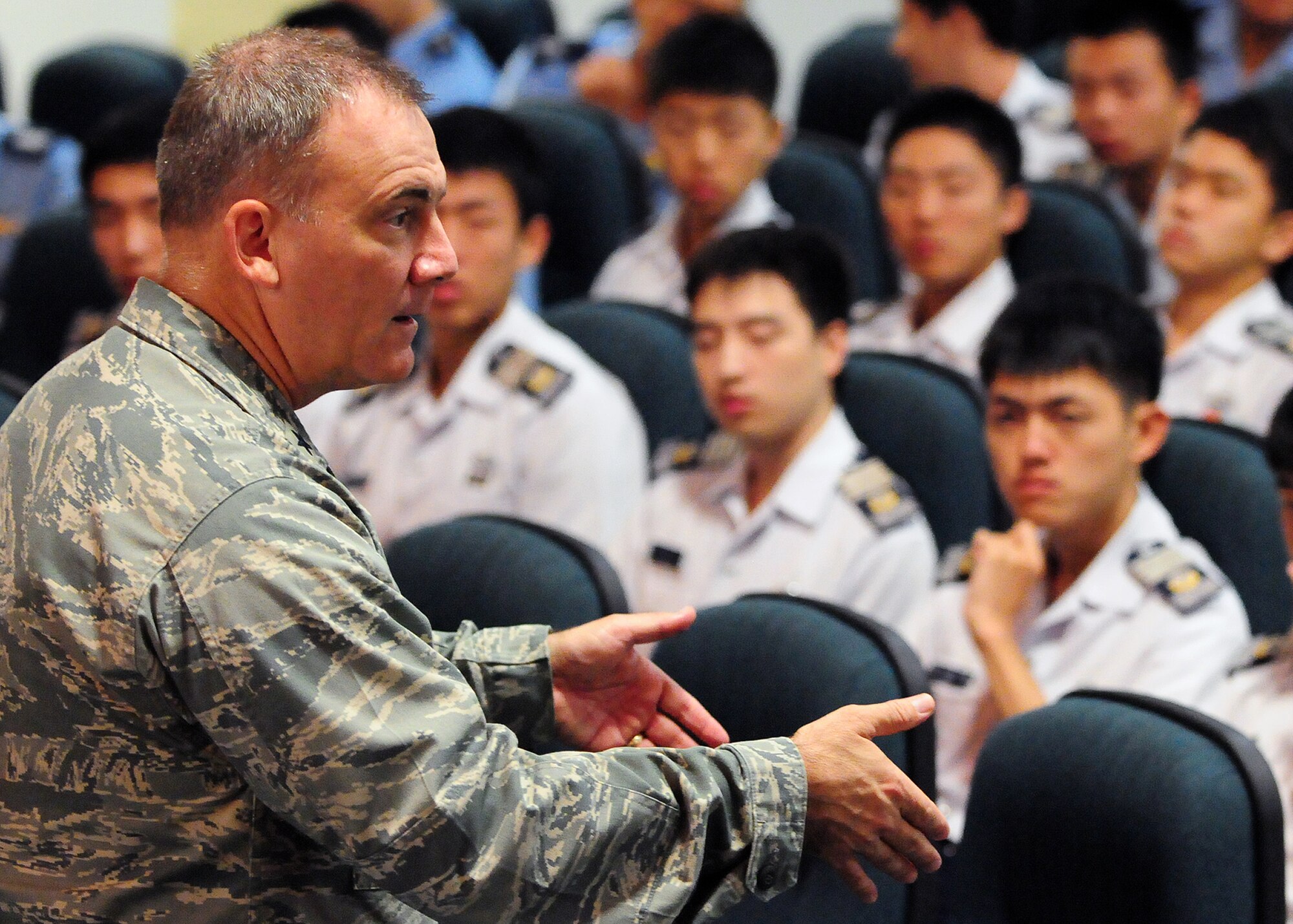 Brig. Gen. John Doucette, 36th Wing commander, speaks to Republic of Korea Air Force Academy cadets about the mission of Andersen Air Force Base, Guam, Nov. 4.  The Cadets spent their first day at Joint Region Marianas Naval Base, Guam. During their visit here the ROKAF Cadets viewed a static display of a U.S. Air Force B-52 Stratofortress aircraft and the RQ-4 Global Hawk. The purpose of the visit was to promote and strengthen the close ties between the allied nations. (U.S. Air Force photo/ Senior Airman Nichelle Anderson)