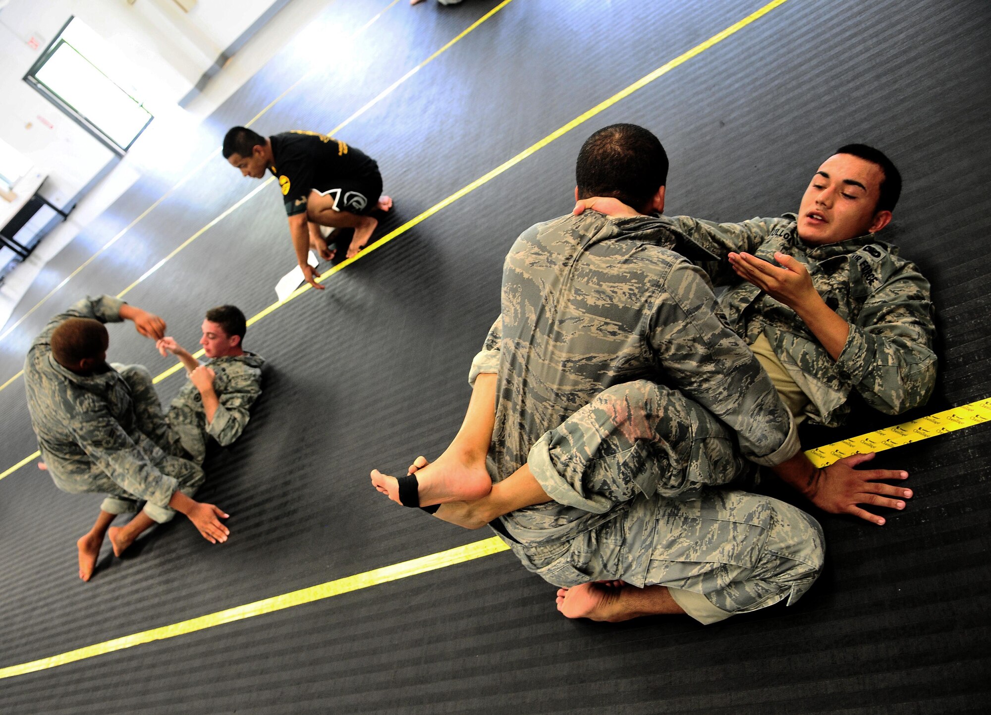 Airmen from the 736th Security Forces Squadron practice submission techniques during an Army Modern Combatives class hosted by the Guam Army National Guard at Fort Juan Muna, Oct. 20. The Airmen learned various styles of combative techniques including Jujitsu and grappling. (U.S. Air Force/Airman Jeffrey Schultze/Released)