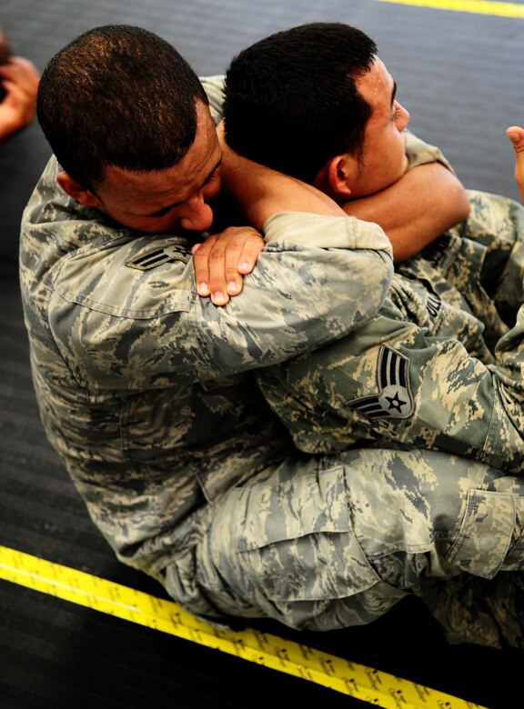 Airman 1st Class Jermaine Bryant and Senior Airman Isaac Ulloa from the 736th Security Forces Squadron practice a submission technique during an Army Modern Combatives class hosted by the Guam Army National Guard at Fort Juan Muna, Oct. 20. The Airmen learned various styles of combative techniques including Jujitsu and grappling. (U.S. Air Force/Airman Jeffrey Schultze/Released)