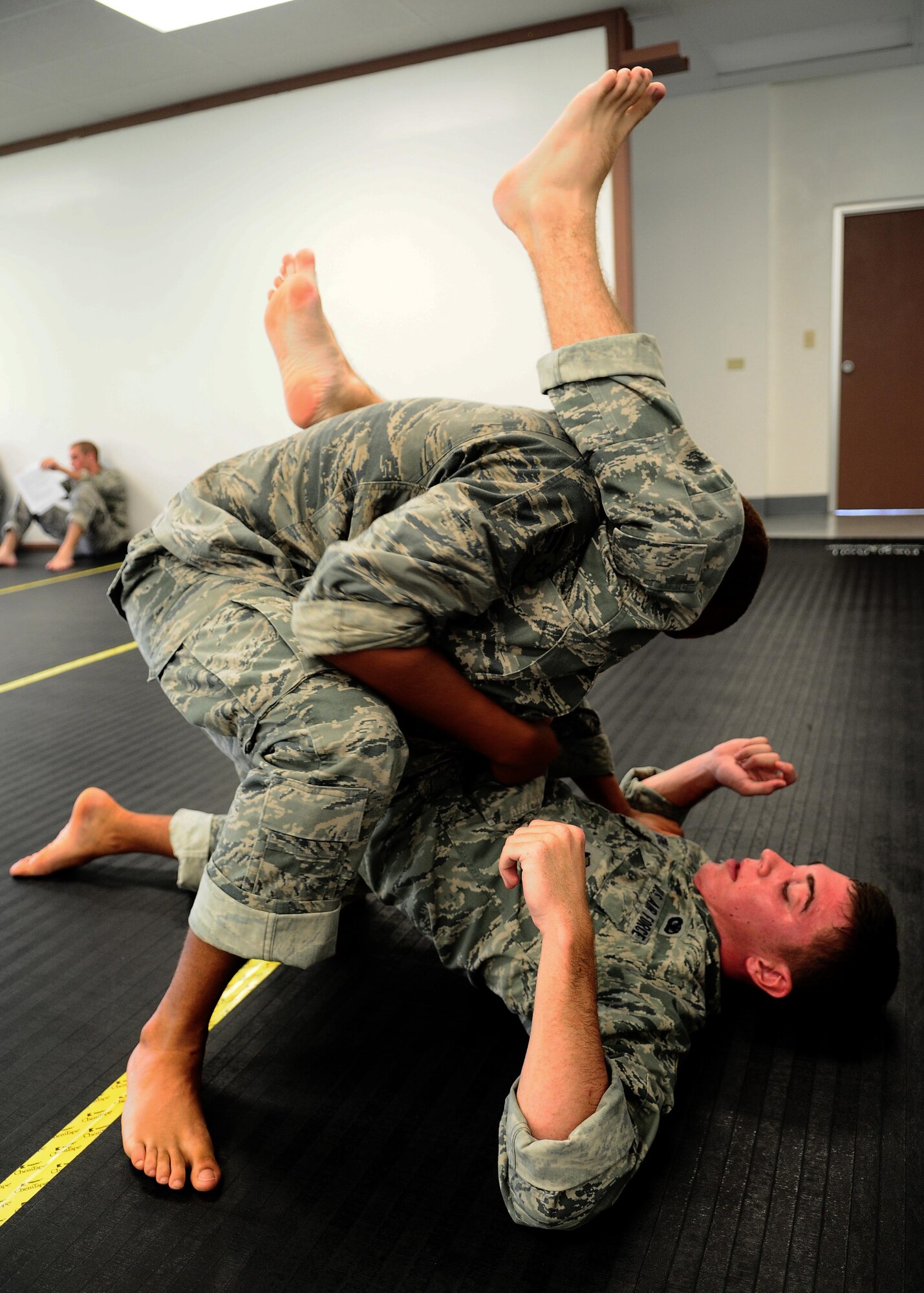 Airmen 1st Class Chris Verble and Darrell Hampton from the 736th Security Forces Squadron practice a submission technique during an Army Modern Combatives class hosted by the Guam Army National Guard at Fort Juan Muna, Oct. 20. The Airmen learned various styles of combative techniques including Jujitsu and grappling. (U.S. Air Force/Airman Jeffrey Schultze/Released)