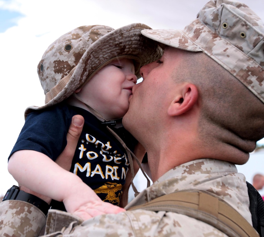 U.S. Marine Corps Cpl. Joshua Williams kisses his 14-month-old son Elijah during his homecoming at Del Valle Field, Marine Corps Air Ground Combat Center Twentynine Palms, Calif., Oct. 4, 2010. Williams is a radio operator for Regimental Combat Team 7.