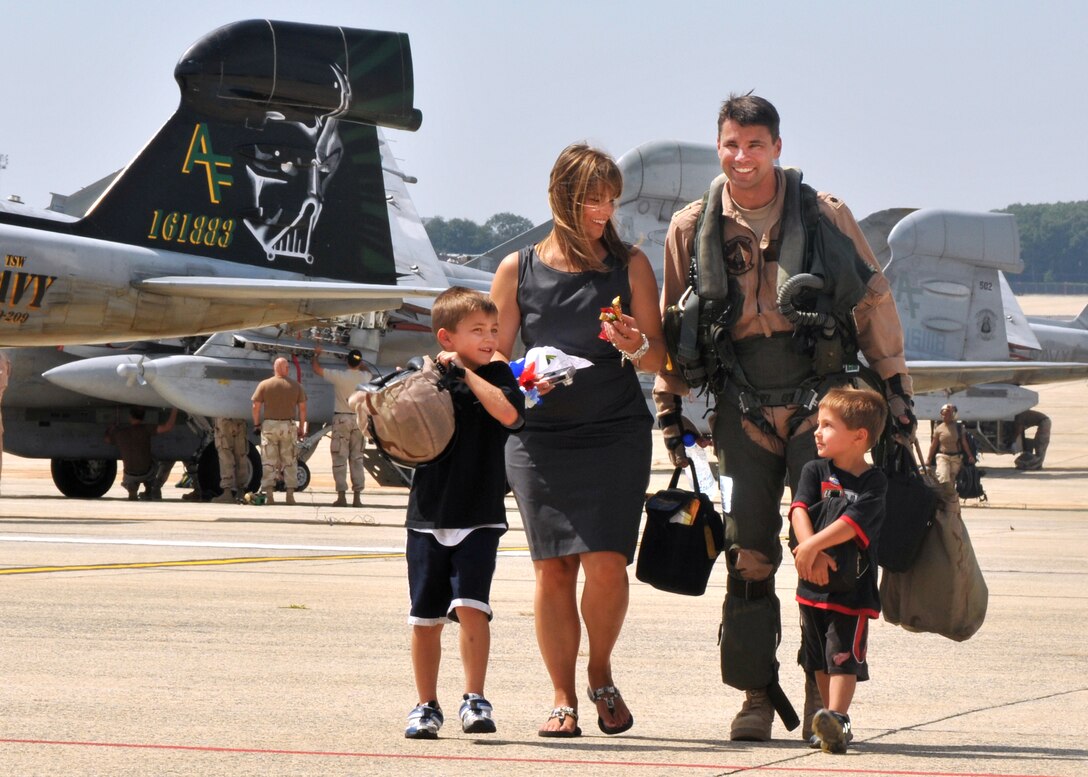 U.S. Navy Cmdr. Michael Esper leaves the flight line with his wife and children during a homecoming celebration at Joint Base Andrews Naval Air Facility, Md., Sept. 7, 2010. Esper is assigned to the Star Warriors of Electronic Attack Squadron 209.